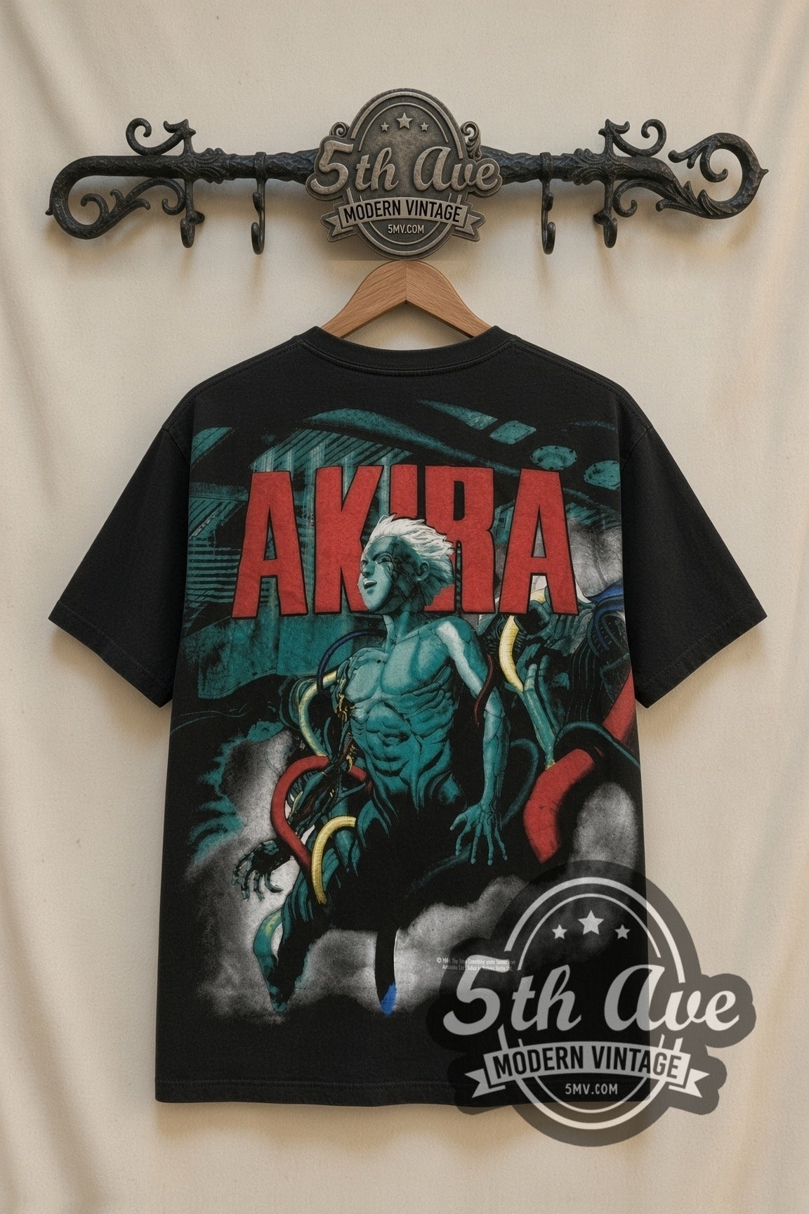 Akira Teal Character all-over-print vintage anime tee in black on the 5MV rack, back view: red AKIRA logo over the teal Tetsuo character art, same graphic as the front