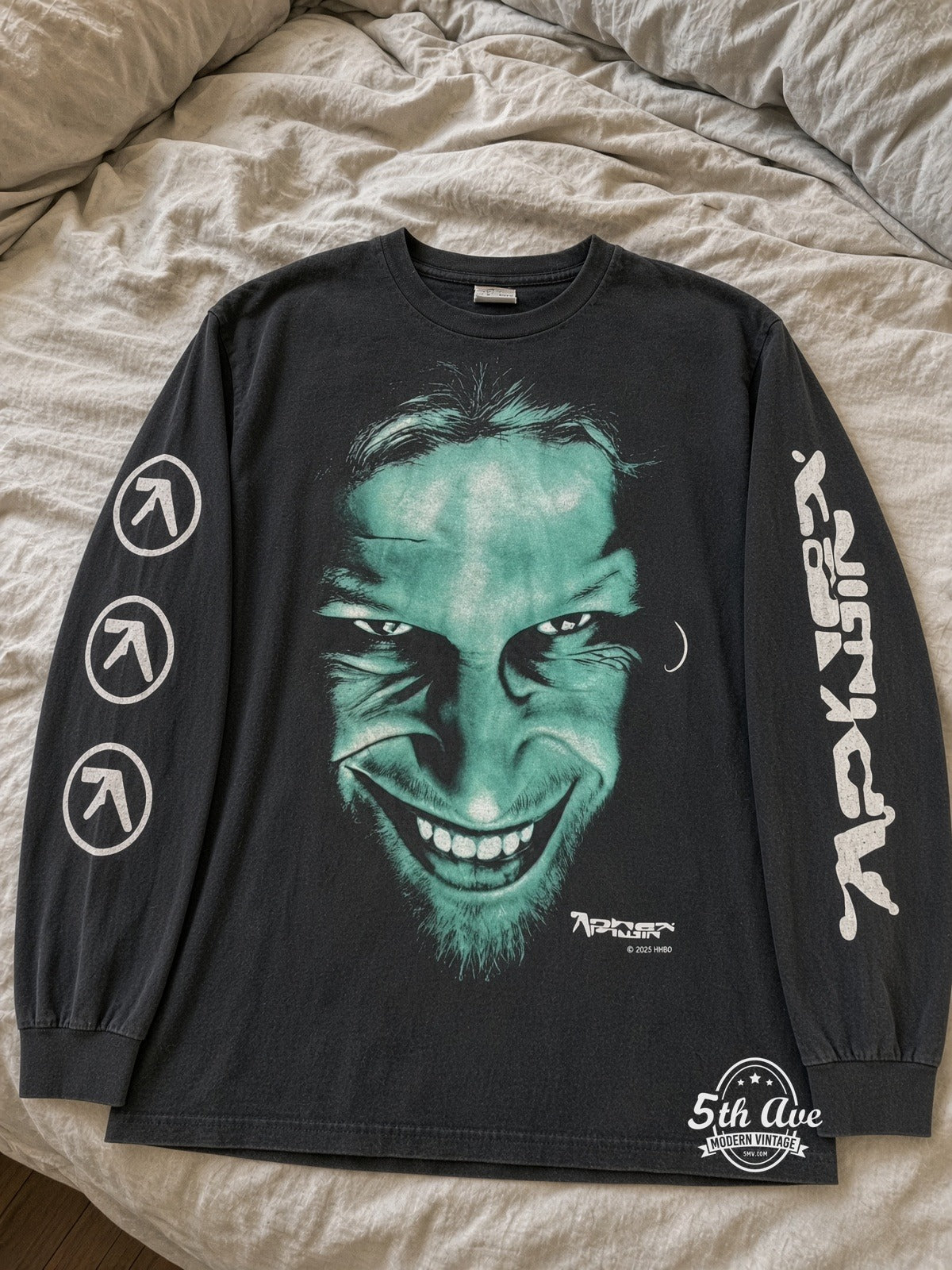 Aphex Twin Richard D. James Grin vintage tee laid on bed