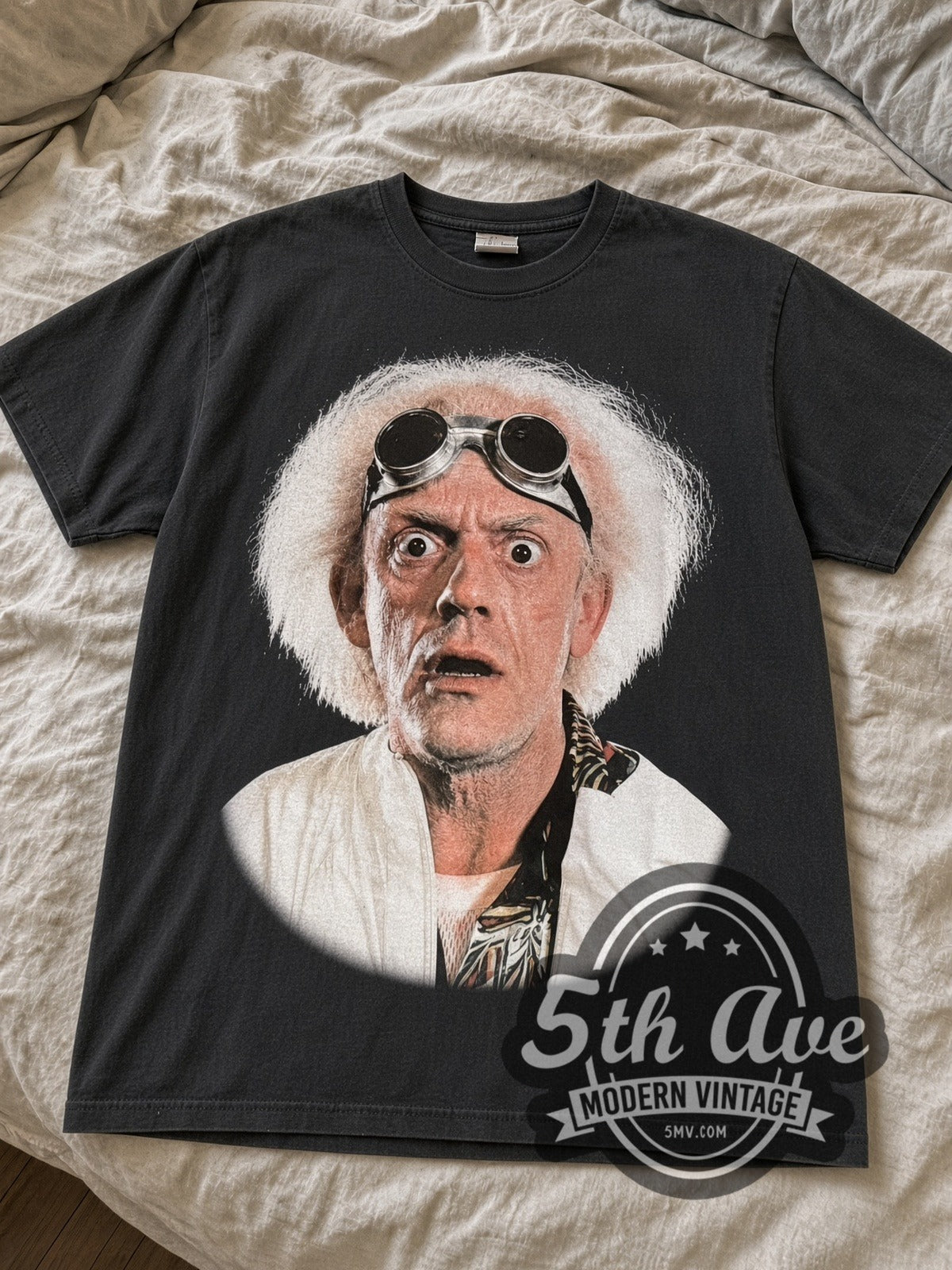 Black Back to the Future Doc Brown tee laid flat on linen bed
