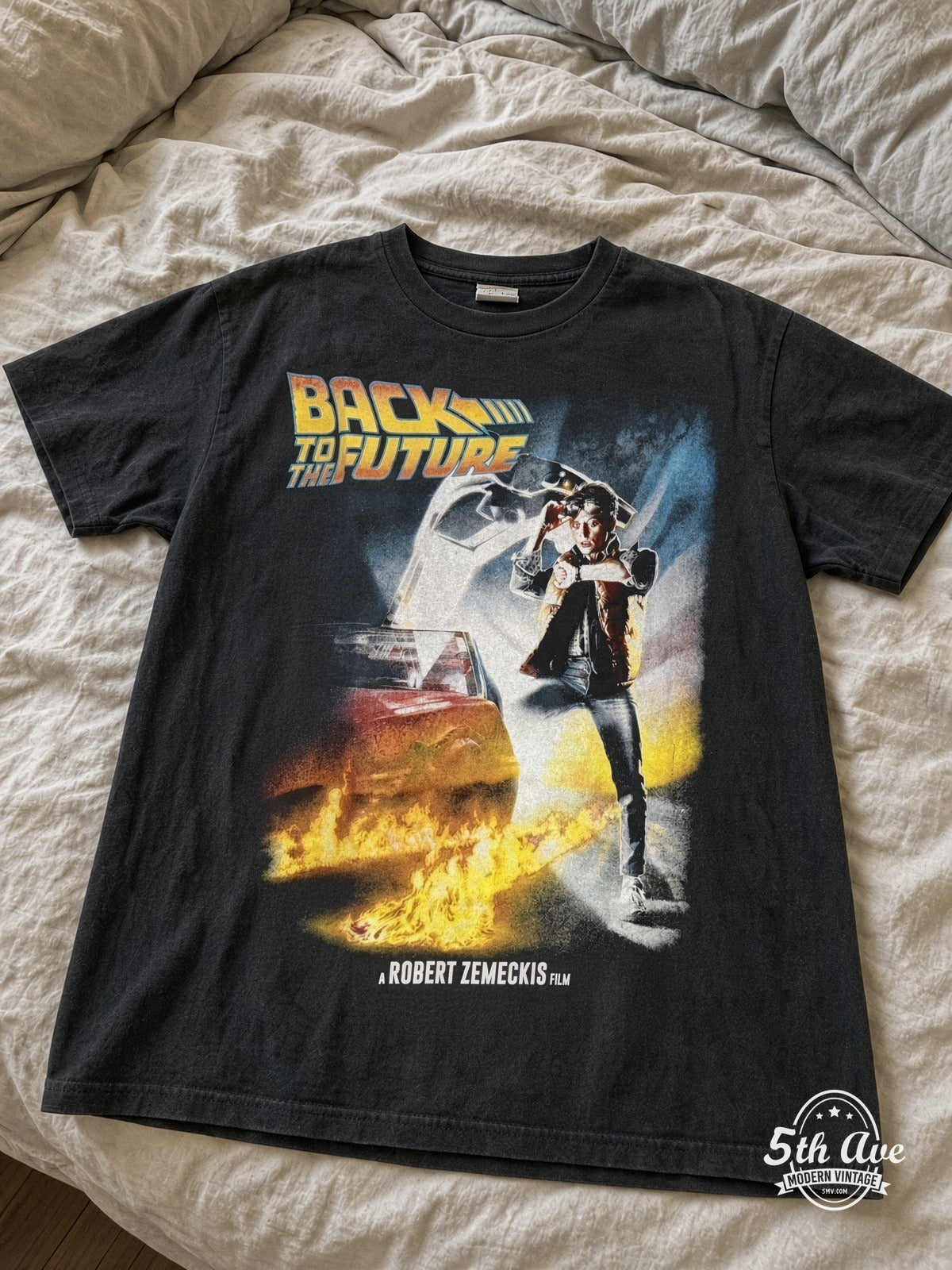 Back to the Future OUTATIME DeLorean vintage tee laid on bed
