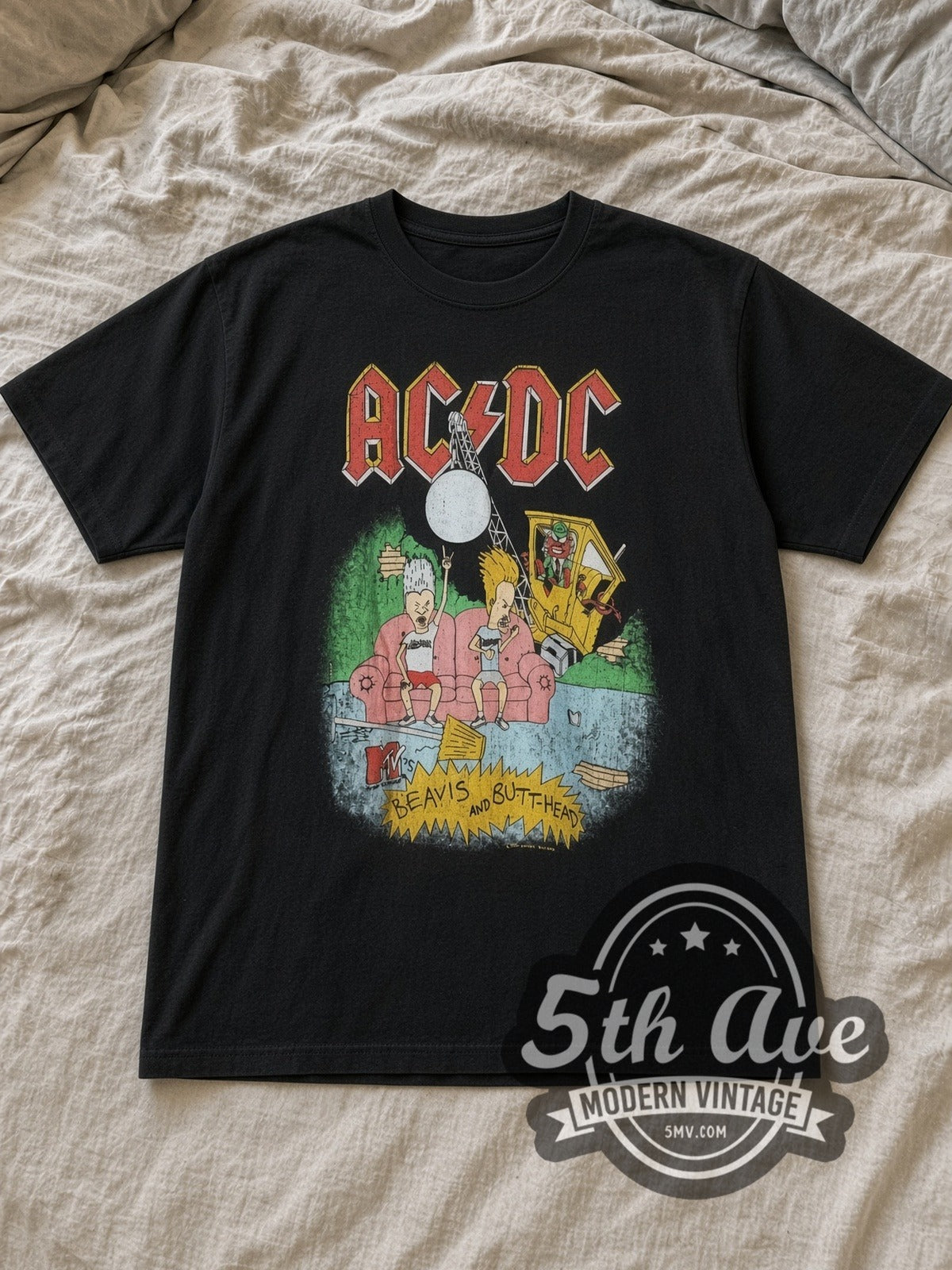 Black AC/DC Beavis and Butt Head / MTV Vintage Band T-Shirt laid flat on a linen bed