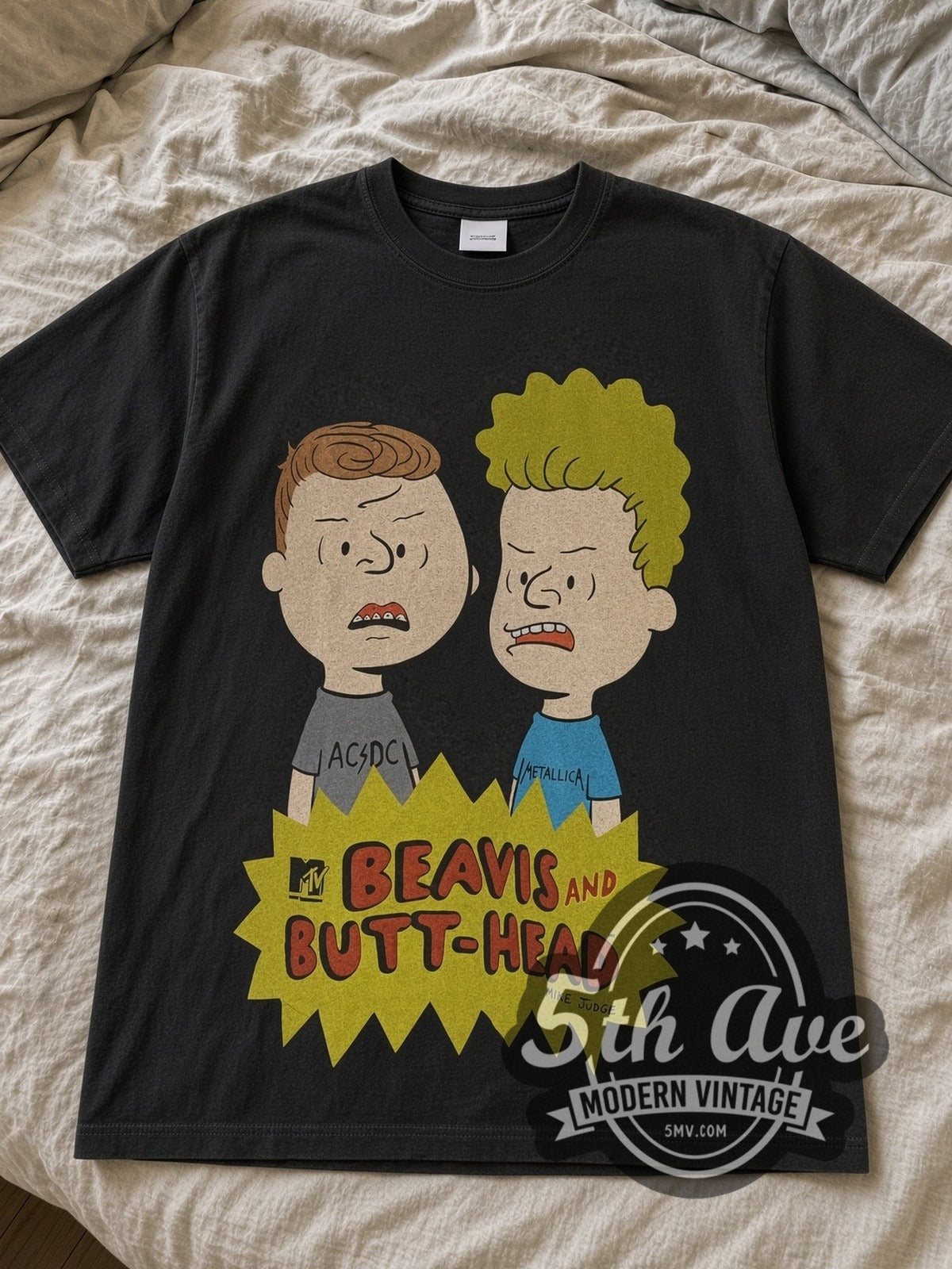 Black Beavis and Butt-Head Comic Strip Couch tee laid flat on linen bed