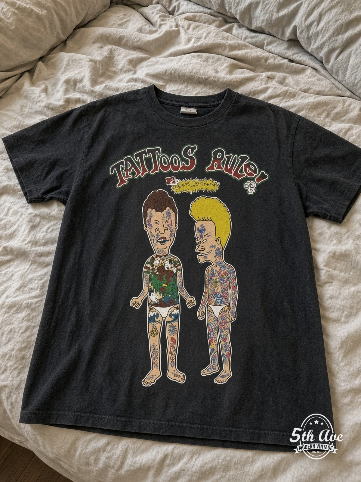Beavis and Butt-Head Tattoos Rule MTV vintage tee laid on bed