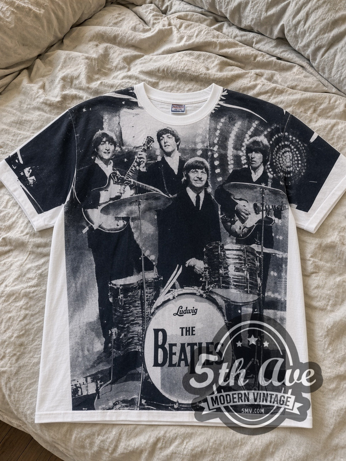 The Beatles Early Era Live Stage Photo vintage band t-shirt – laid flat on bed