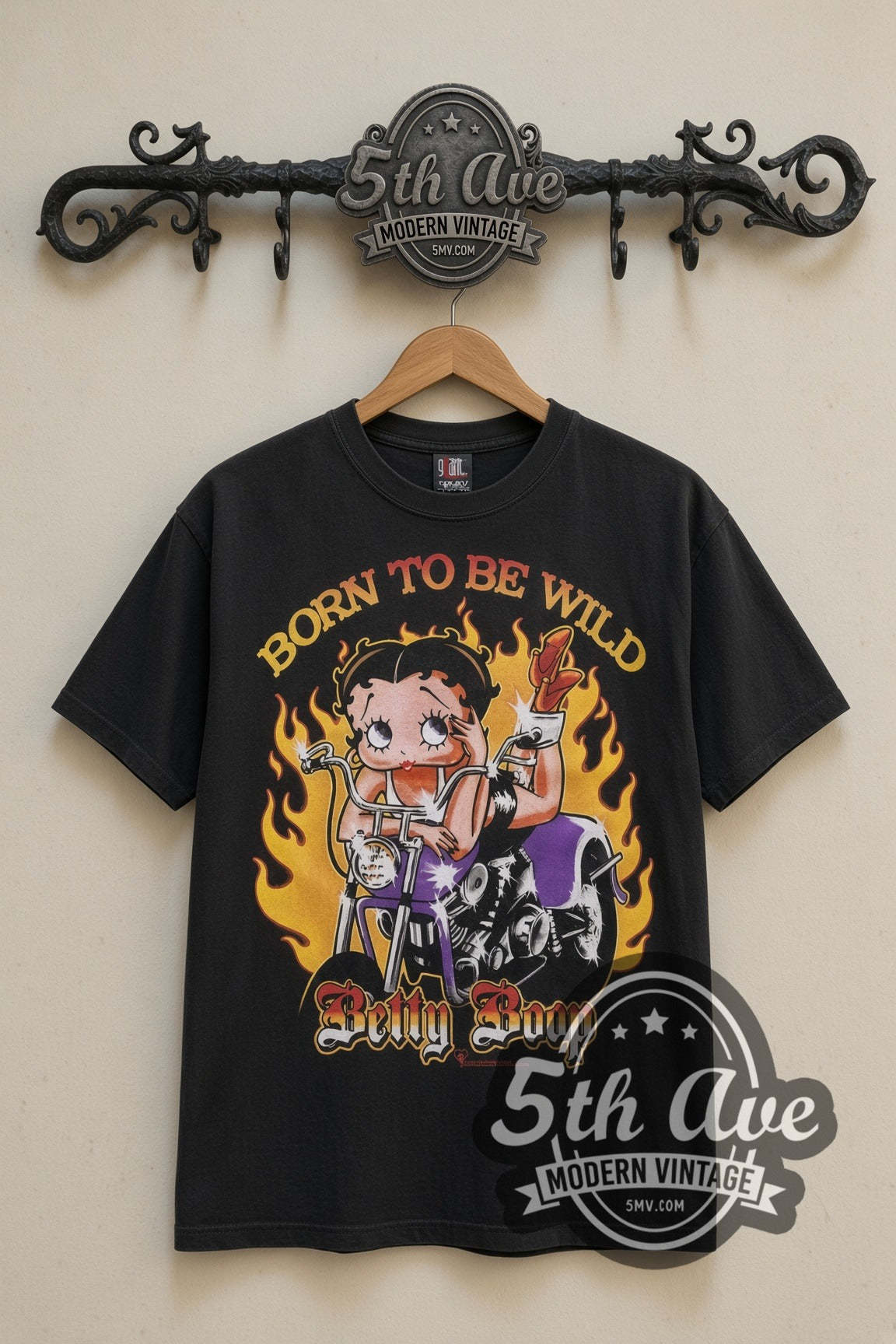 Betty Boop Born to Be Wild Biker cartoon tee in black, front view on a display rack