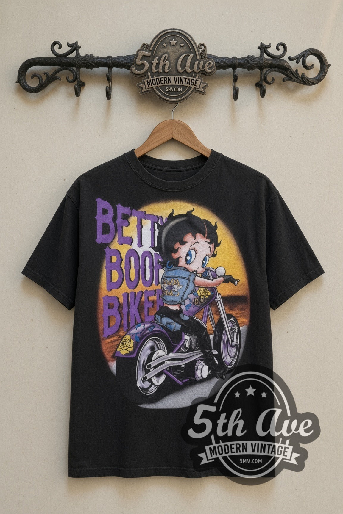 Betty Boop Born to Be Wild Biker cartoon tee in black, back view on a display rack