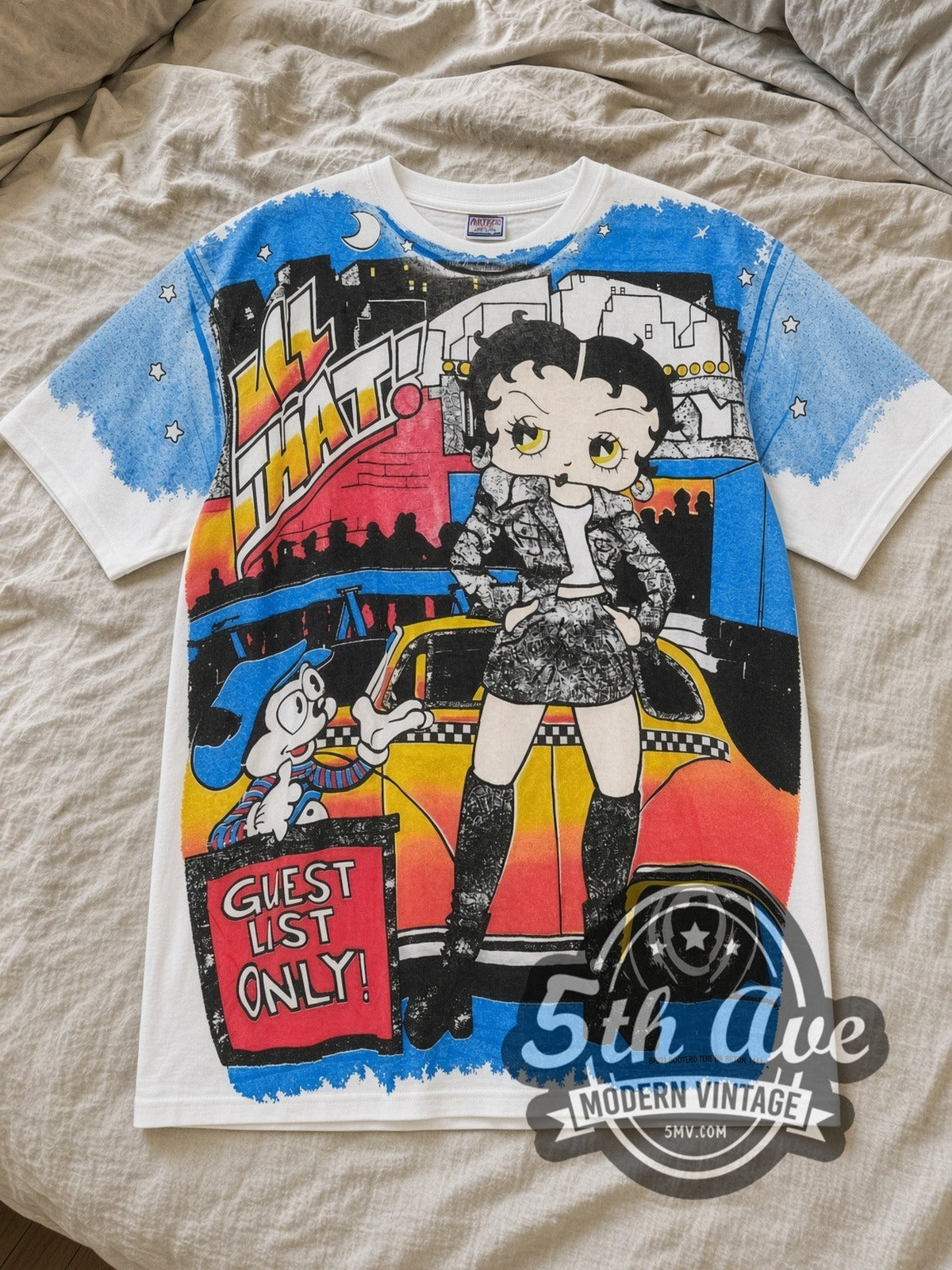 White Betty Boop Guest List Only All Over Print Vintage Cartoon T-Shirt laid flat on a linen bed