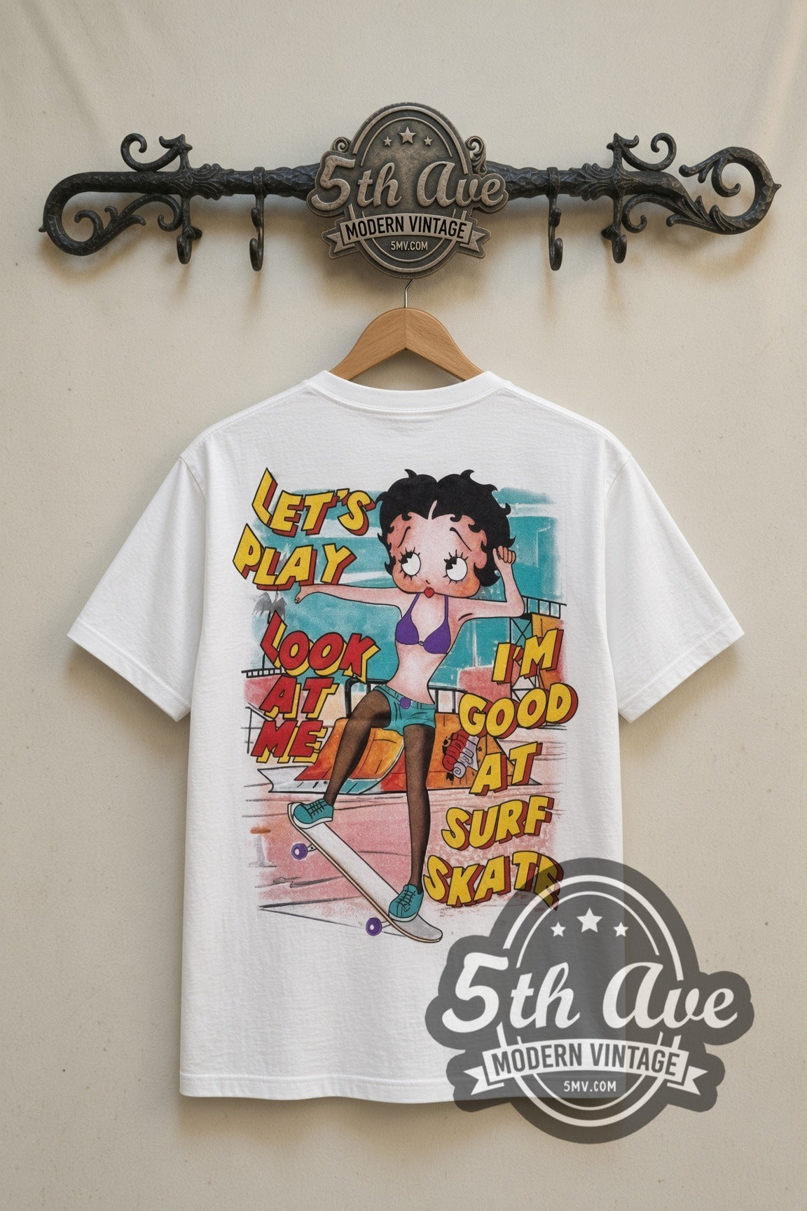 Betty Boop I'm Good at Surf Skate cartoon tee in white, back view on a display rack