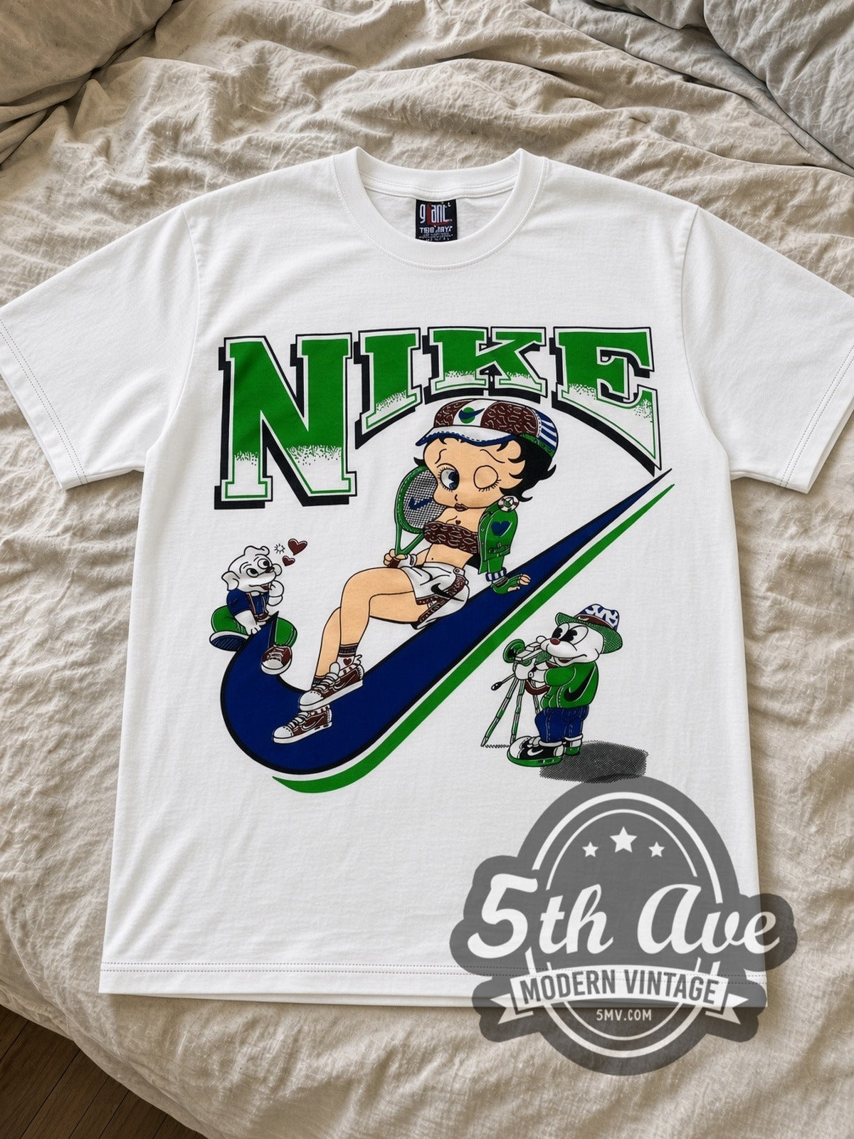 Betty Boop Nike Swoosh cartoon tee in white laid flat on a bed, front artwork