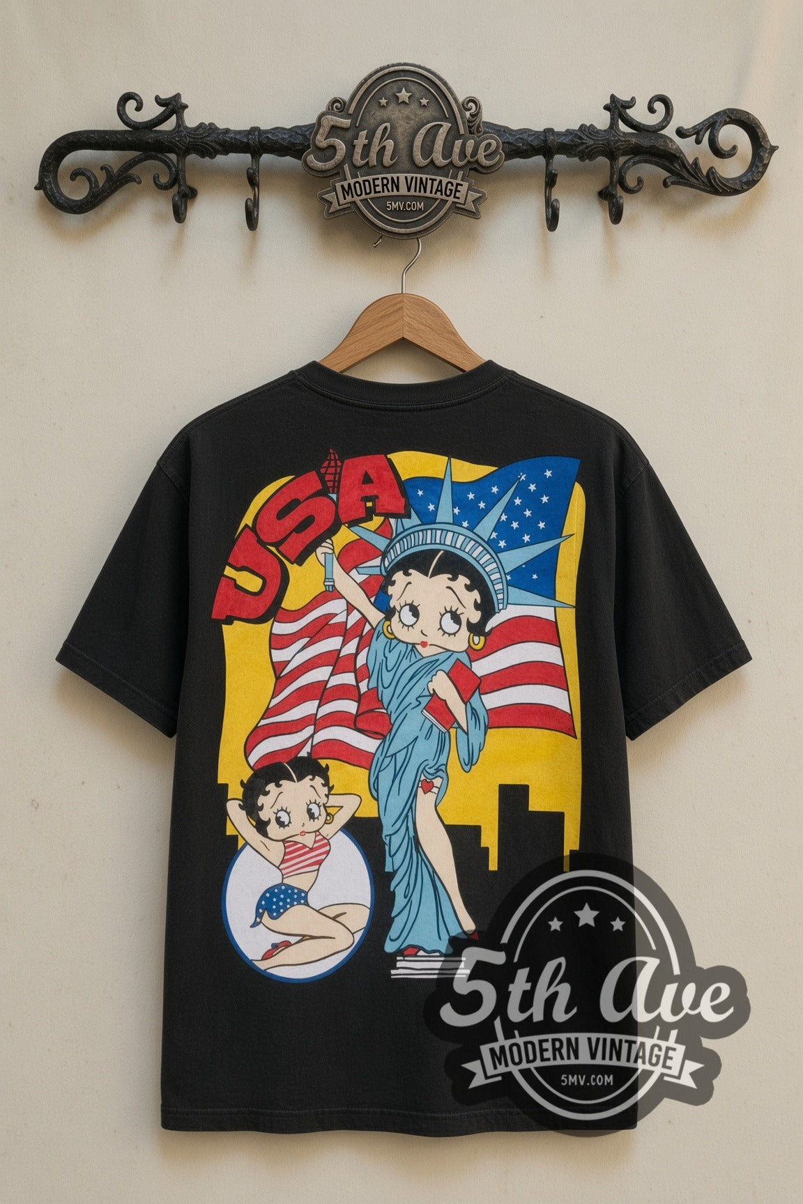 Betty Boop USA Statue of Liberty cartoon tee in black, back view on a display rack