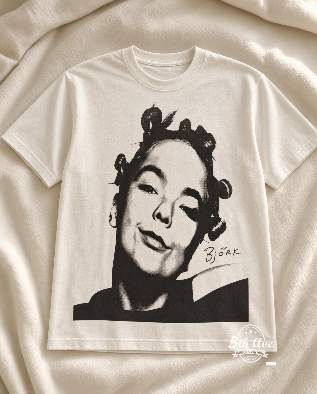 Björk It Take Courage to Enjoy It vintage t-shirt laid on bed