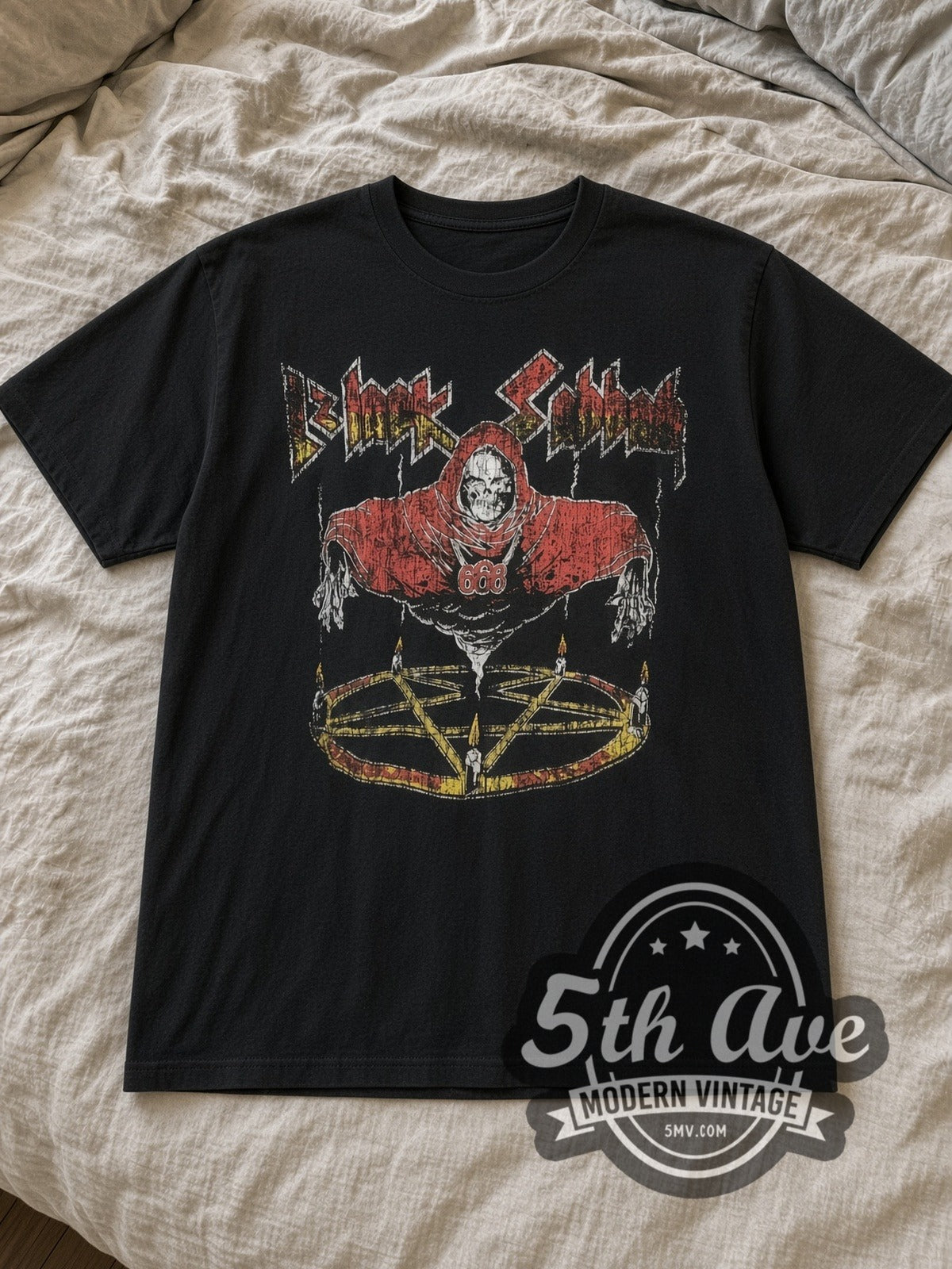 Black Sabbath Red Hooded Skeleton Reaper 666 Vintage Band T-Shirt in black, laid flat on a linen bed