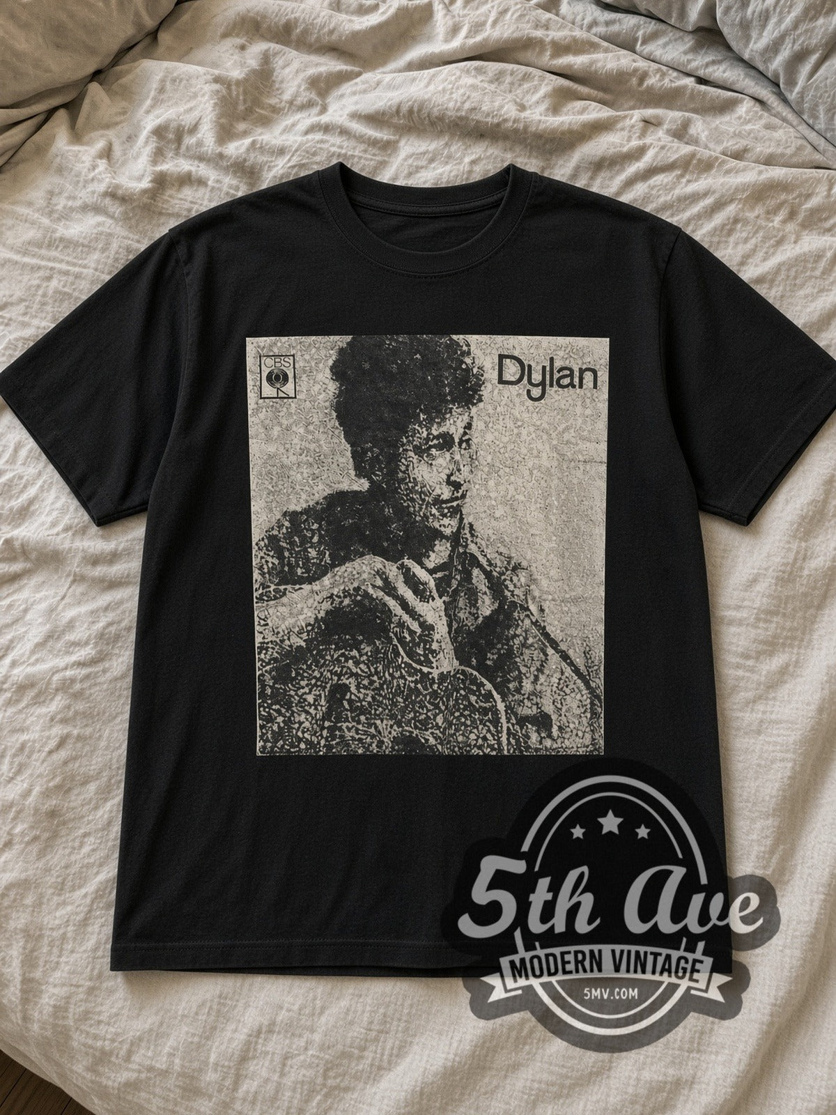 Black Bob Dylan Guitar Portrait Vintage Band T-Shirt laid flat on a linen bed