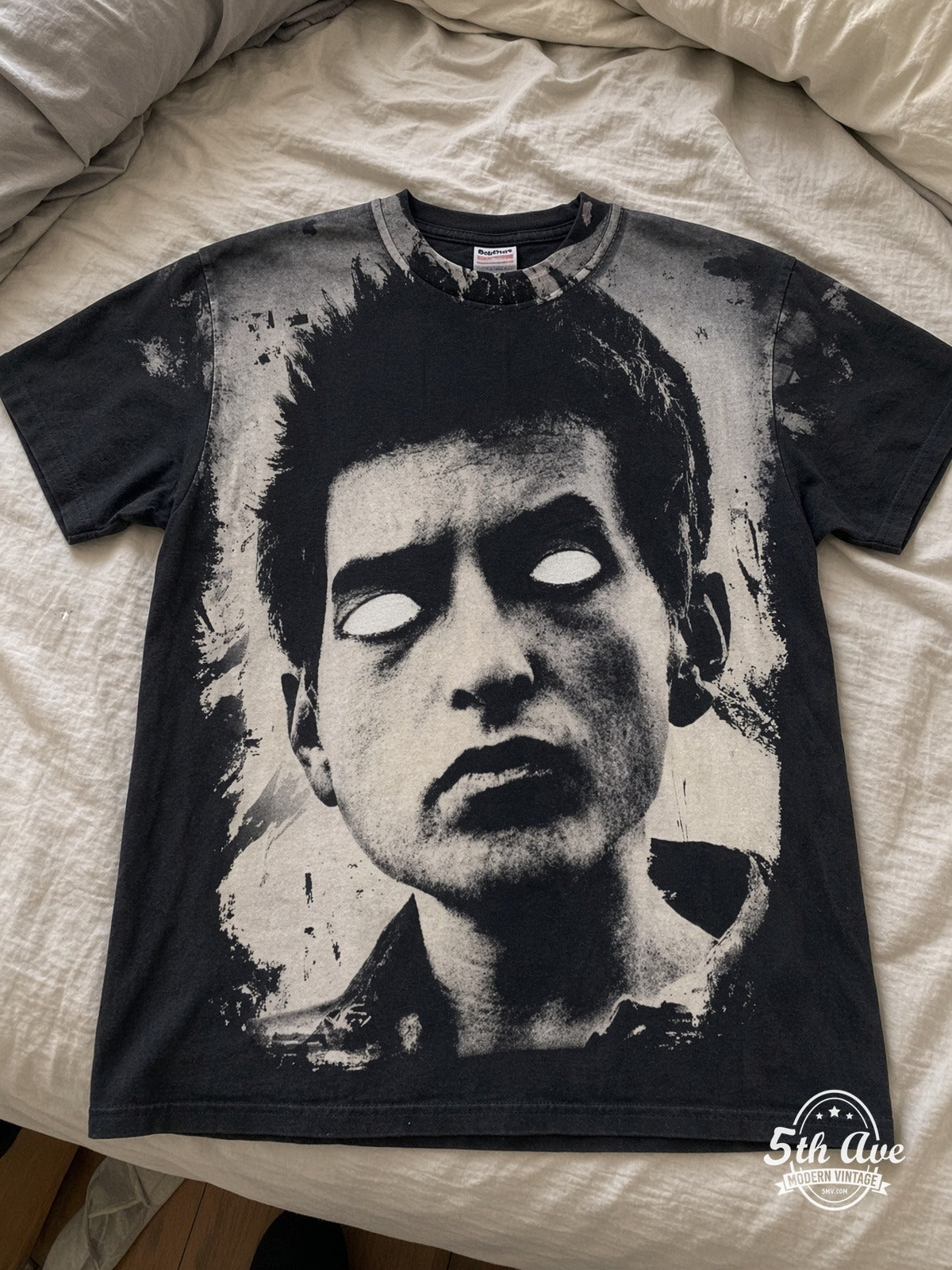 Bob Dylan Blank-Eye Distressed Portrait vintage tee laid on bed
