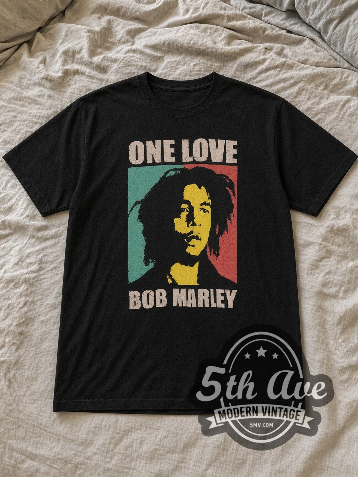 Black Bob Marley One Love Vintage Band T-Shirt laid flat on a linen bed