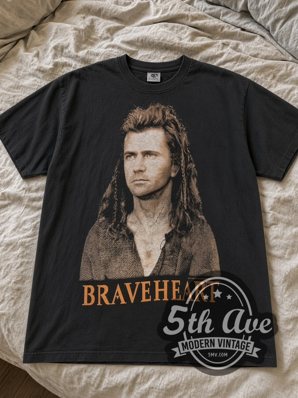Black Braveheart Mel Gibson Portrait & Battle Scene tee laid flat on linen bed
