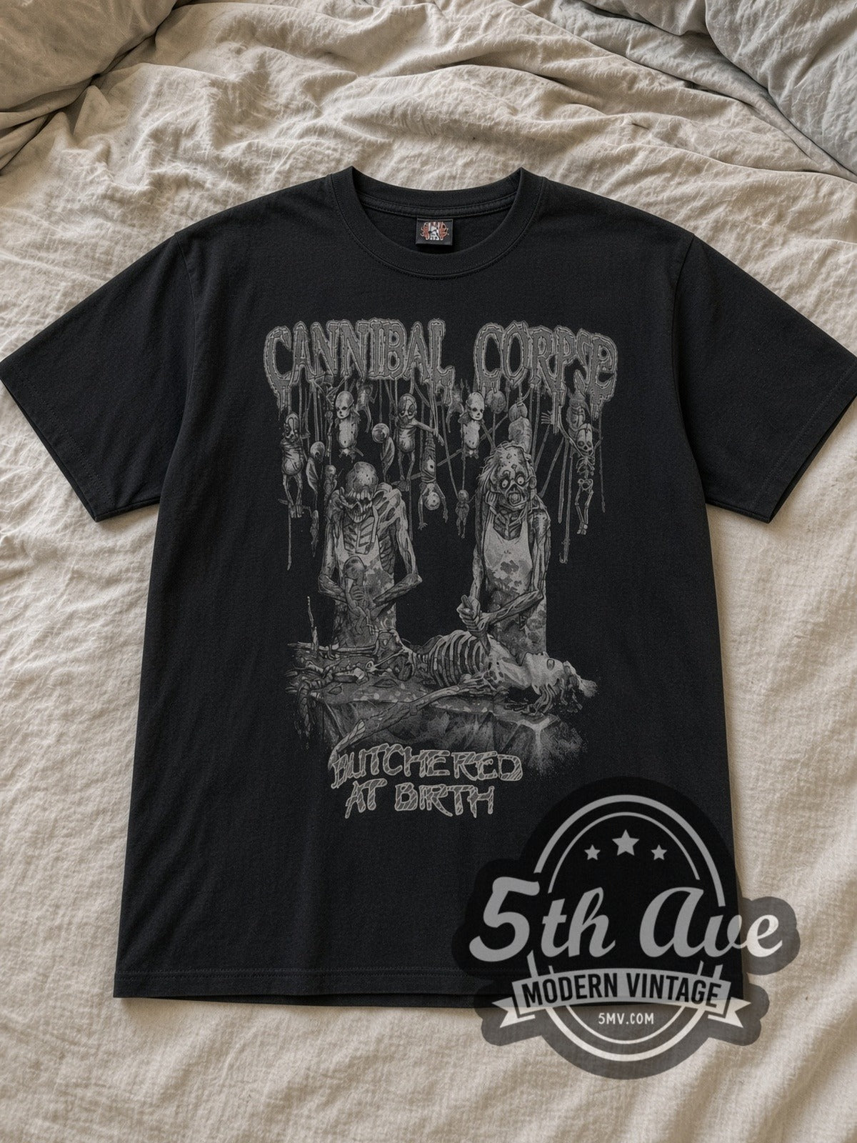 Black Cannibal Corpse Butchered at Birth Vintage Band T-Shirt laid flat on a linen bed