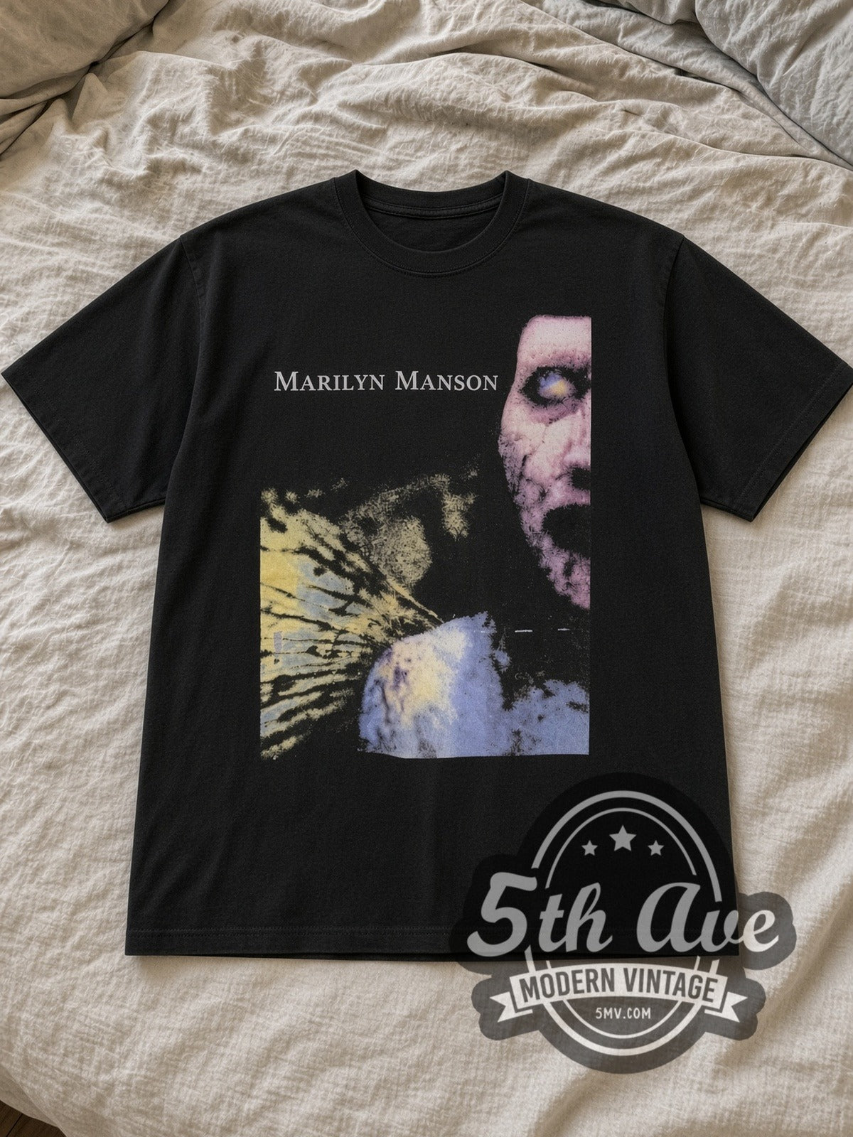 Black Marilyn Manson Portrait Graphic Vintage Band T-Shirt laid flat on a linen bed