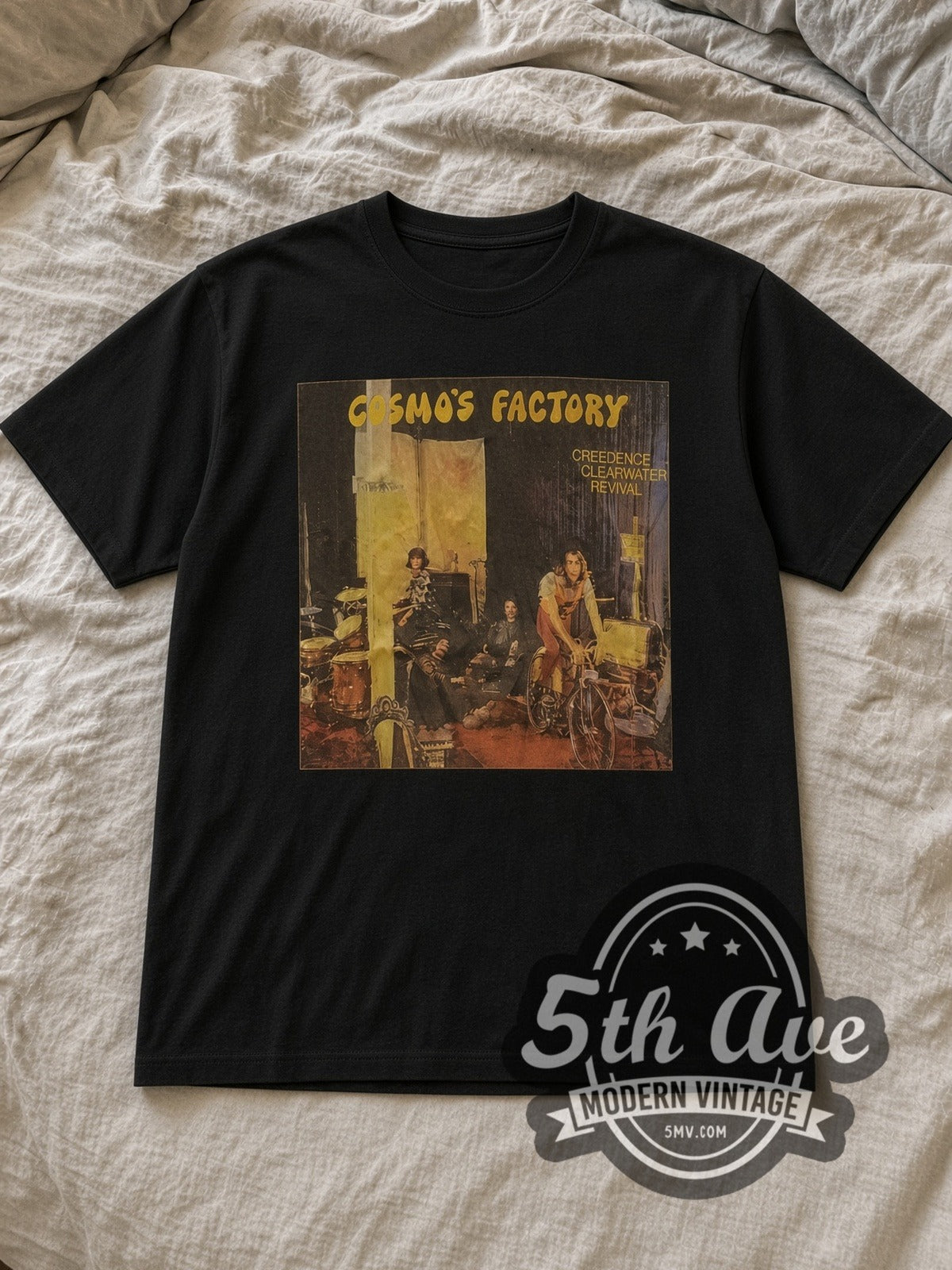 Black Creedence Clearwater Revival Cosmo's Factory Vintage Band T-Shirt laid flat on a linen bed