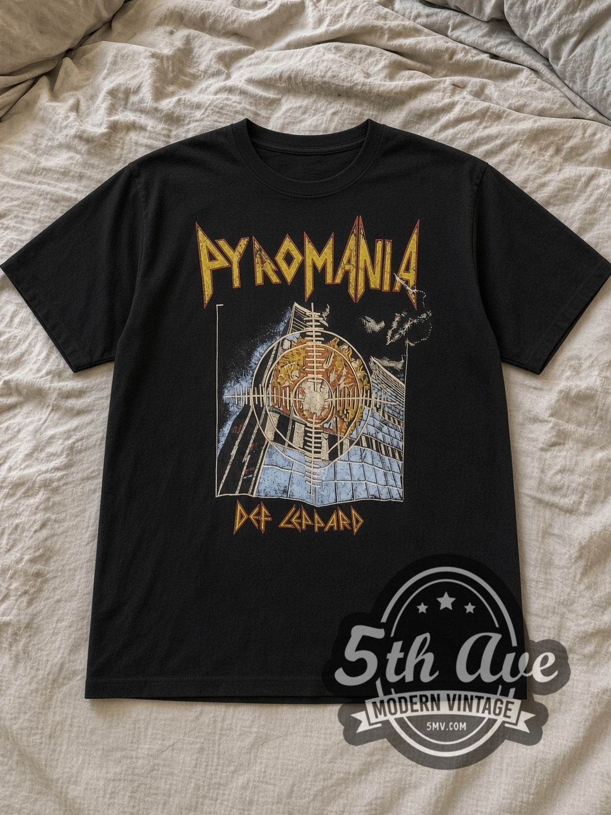 Black Def Leppard Pyromania Burning Building Target Vintage Band T-Shirt laid flat on a linen bed