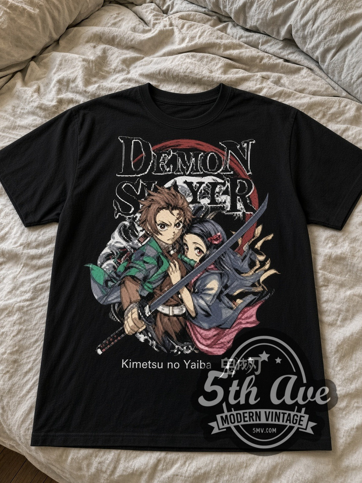 Demon Slayer Tanjiro and Nezuko black graphic tee laid flat on linen bed