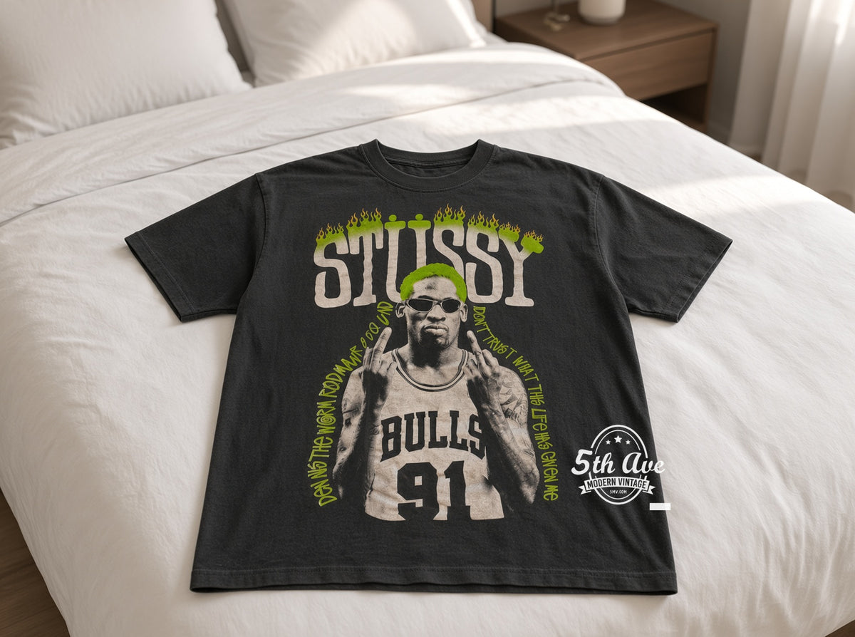 Dennis Rodman x Stüssy Neon Green The Worm vintage t-shirt laid on bed