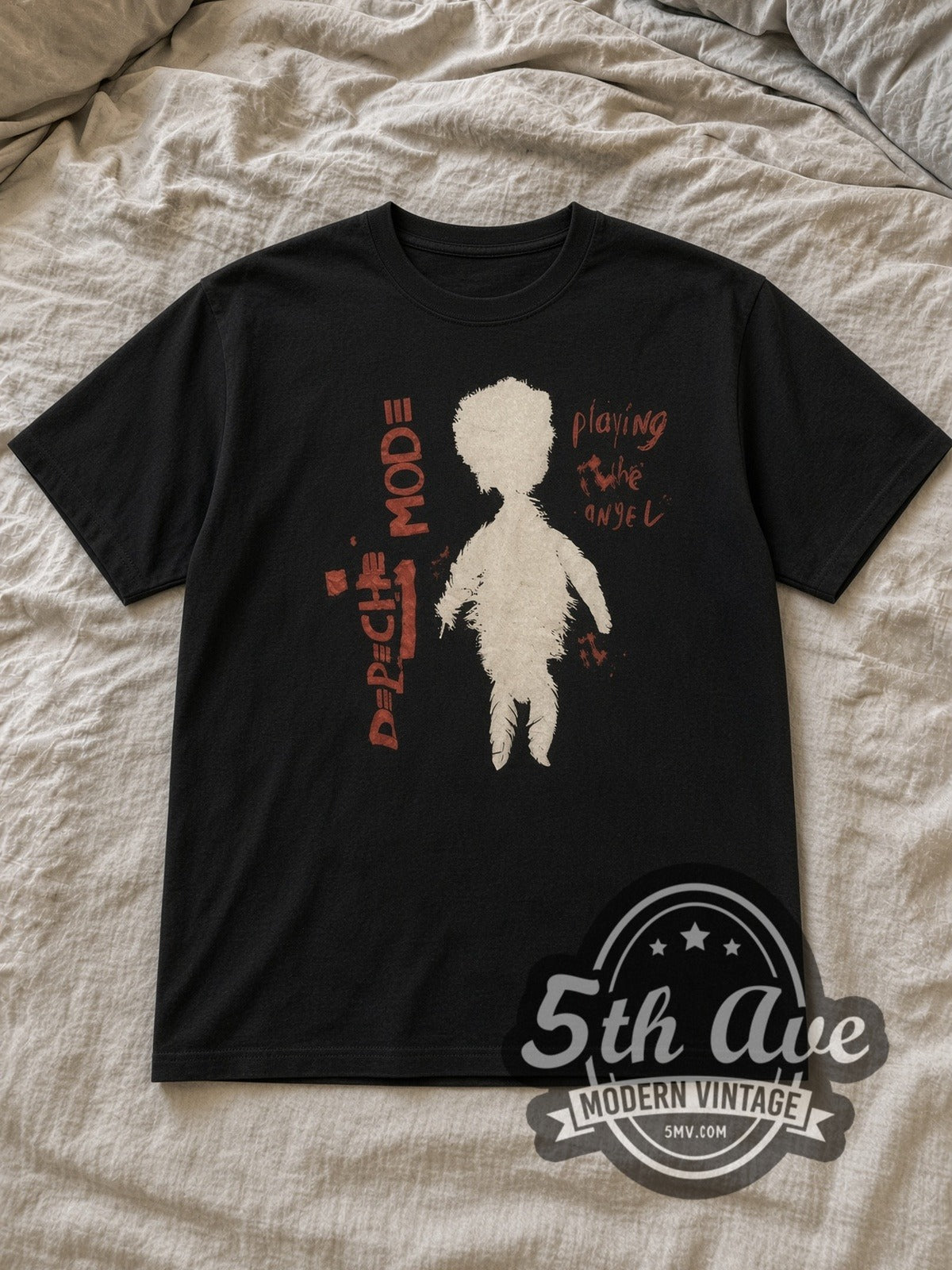 Black Depeche Mode Playing the Angel Vintage Band T-Shirt laid flat on a linen bed