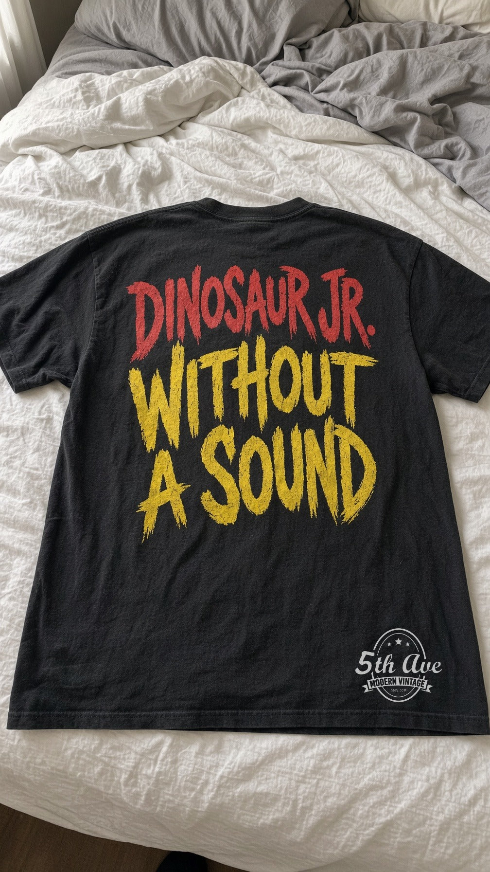 Dinosaur Jr Without a Sound Yellow Back vintage t-shirt laid on bed