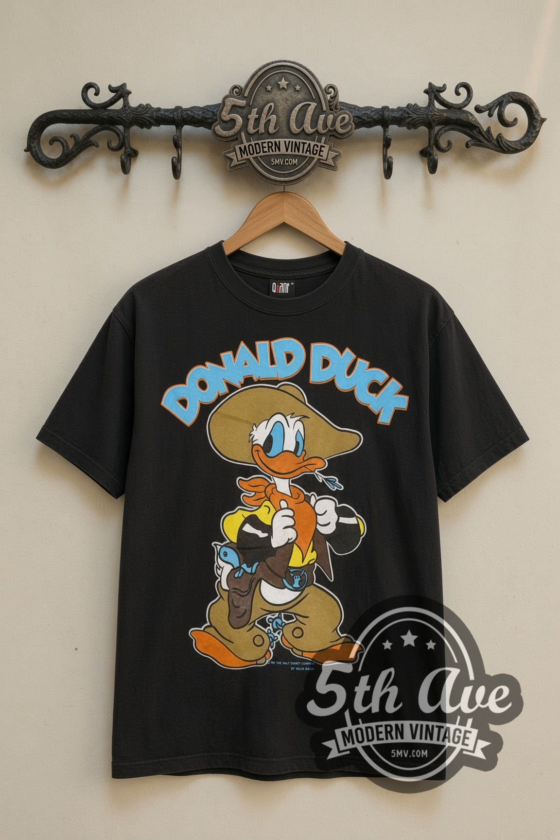 Disney Donald Duck Cowboy and DuckTales Scrooge cartoon tee in black, front view on a display rack