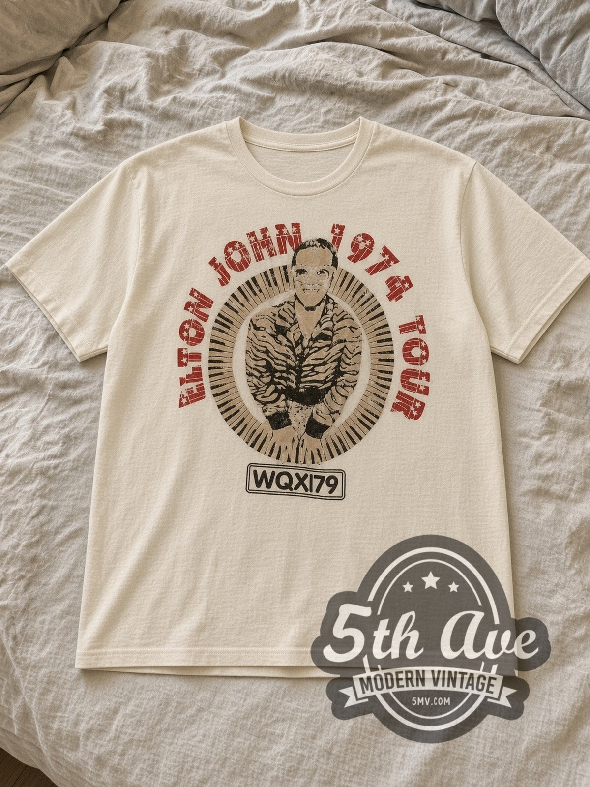 Sand Elton John 1974 Tour Concert Vintage Band T-Shirt laid flat on a linen bed