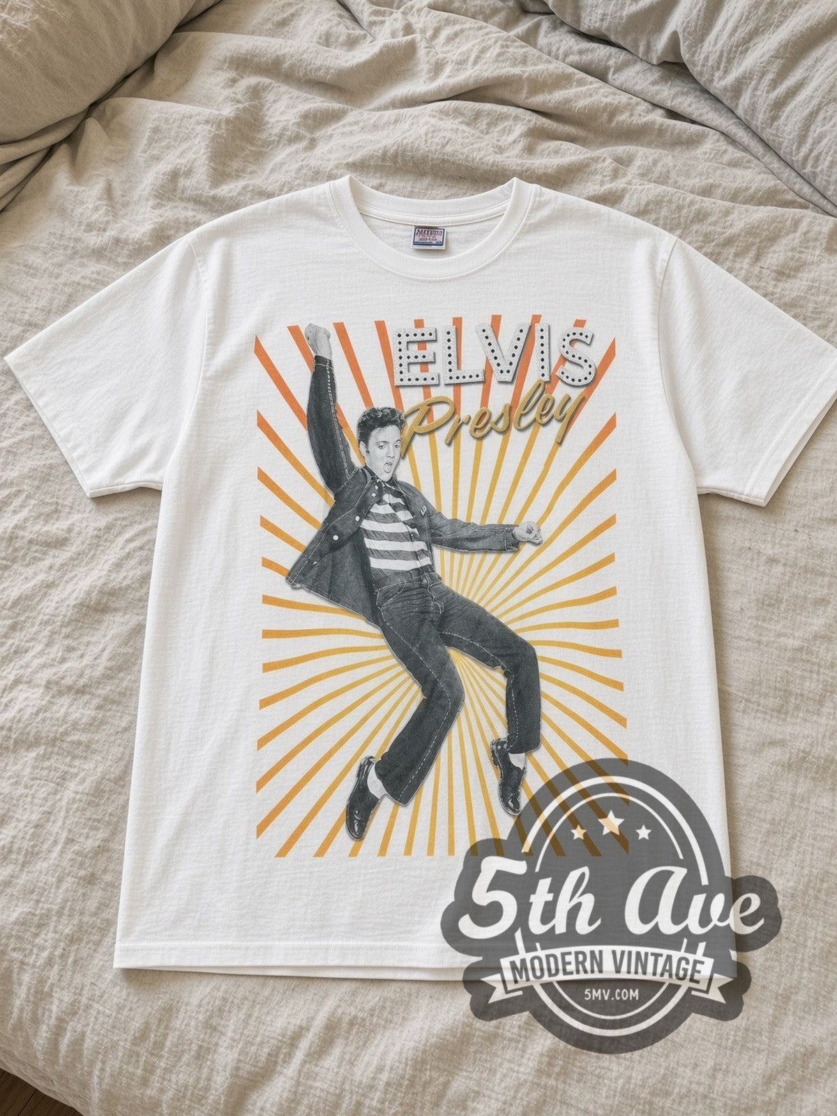 White Elvis Presley King of Rock and Roll Vintage Band T-Shirt laid flat on a linen bed