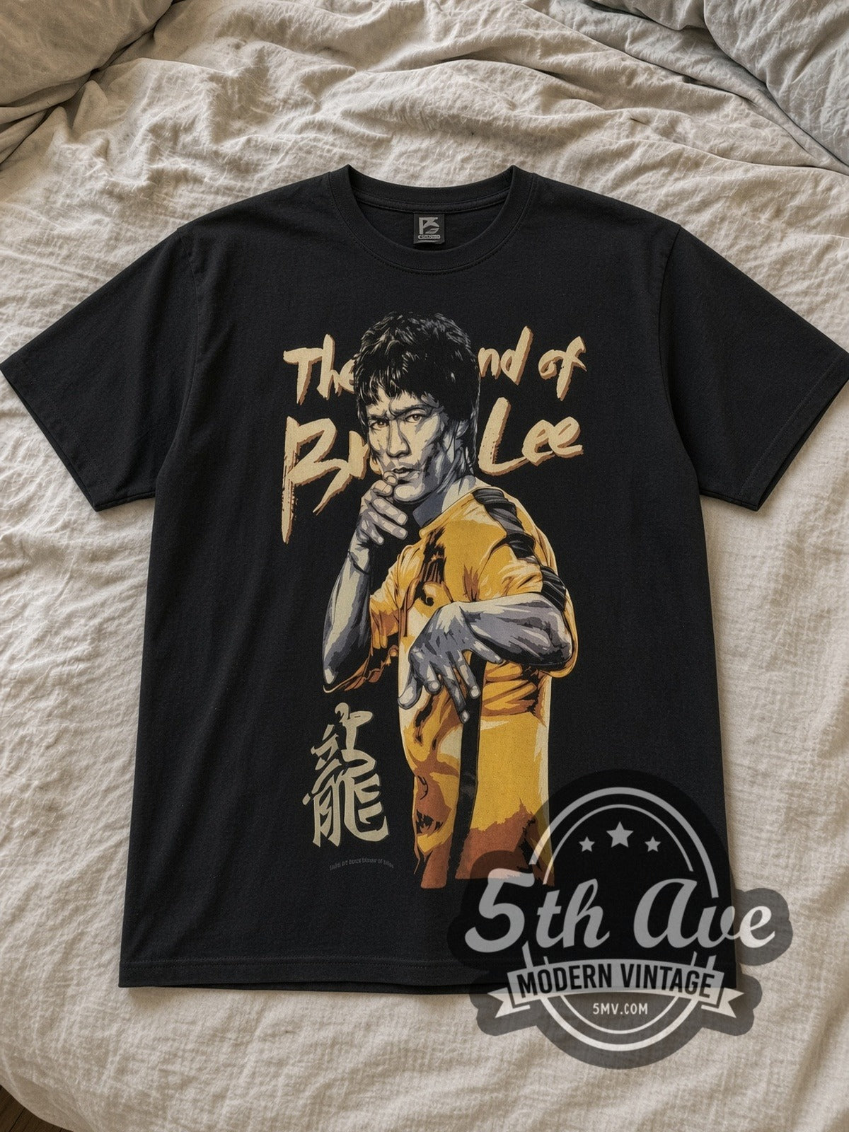 Black Bruce Lee Enter the Legend Vintage Movie T-Shirt laid flat on a linen bed