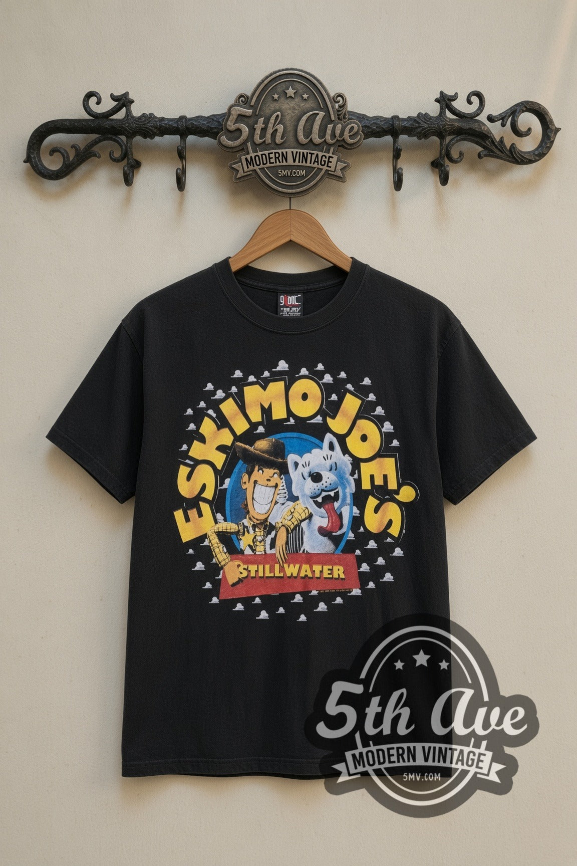 Eskimo Joe's Stillwater Joes Story cartoon tee in black, front view on a display rack