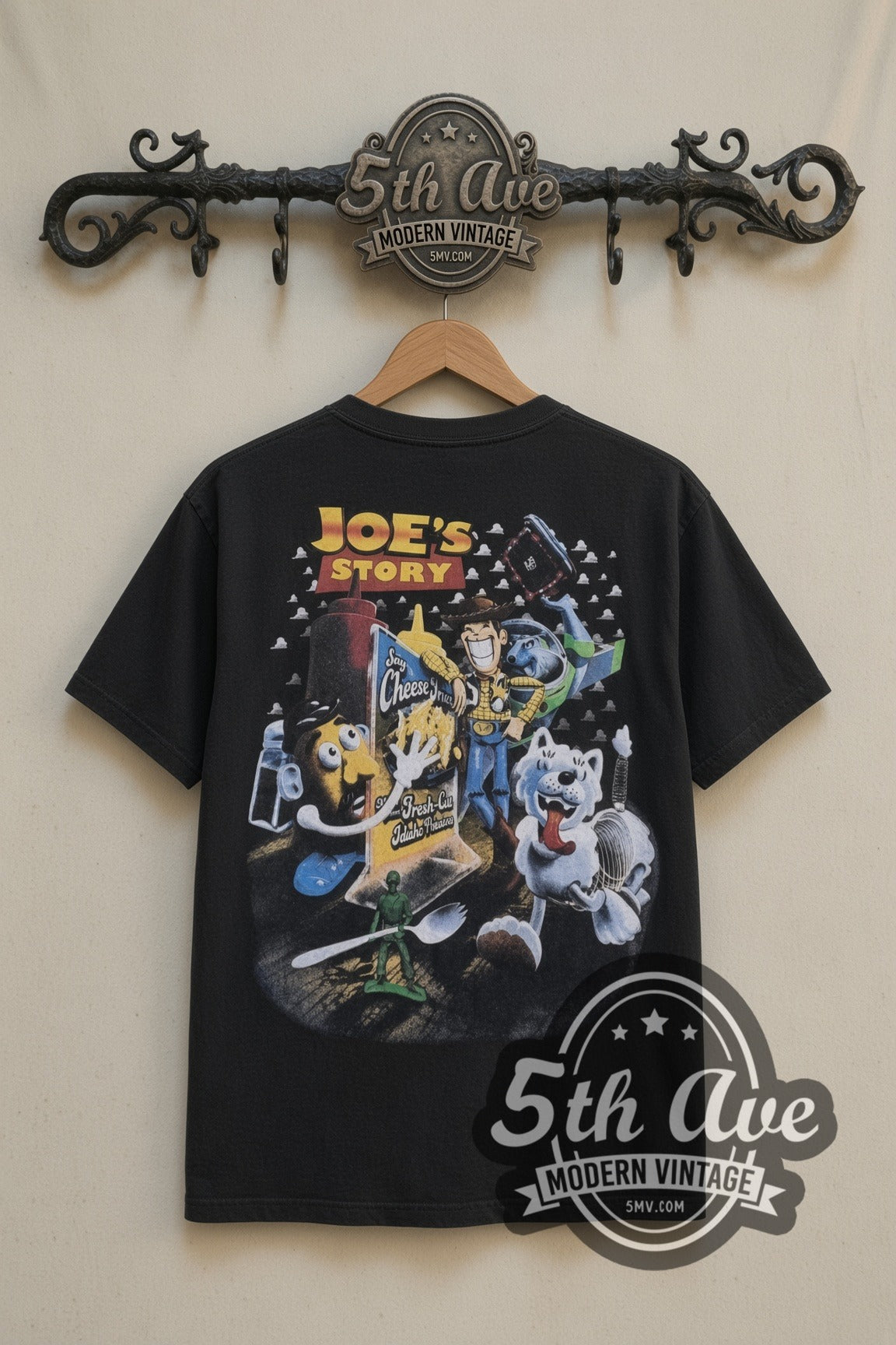 Eskimo Joe's Stillwater Joes Story cartoon tee in black, back view on a display rack
