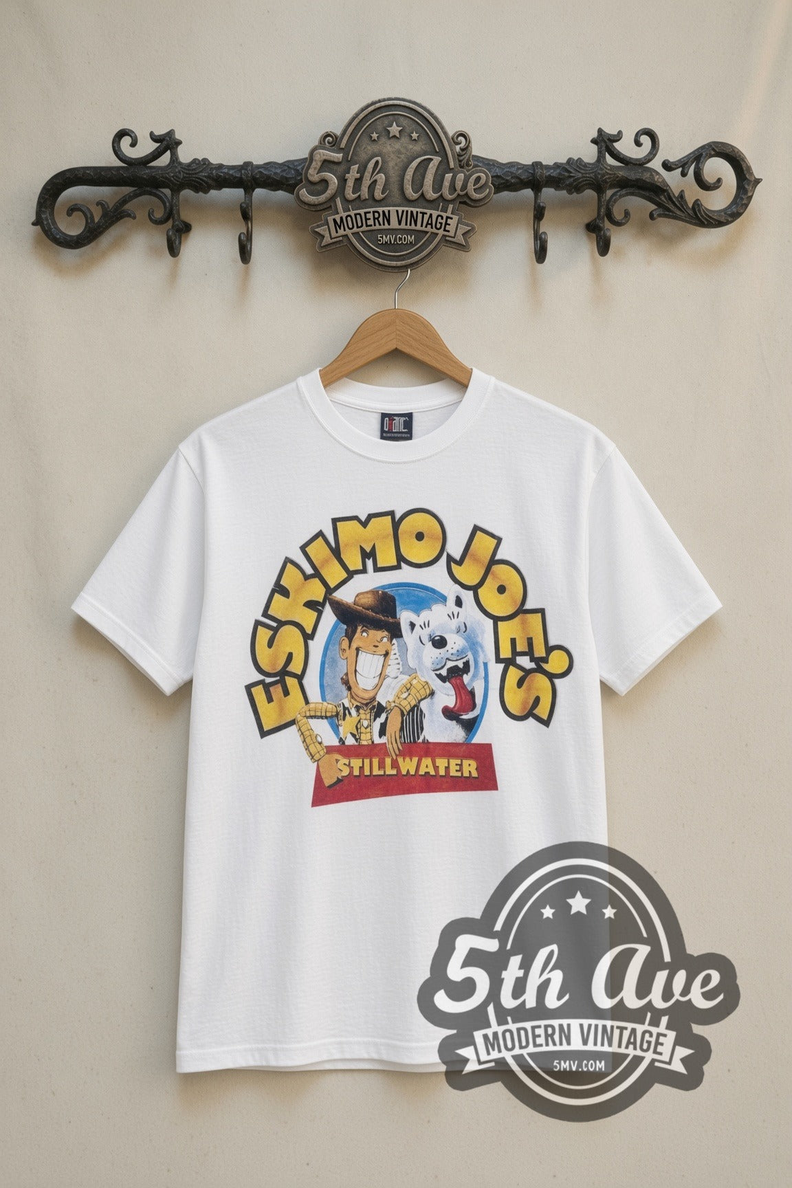 Eskimo Joe's Stillwater Joes Story cartoon tee in white, front view on a display rack