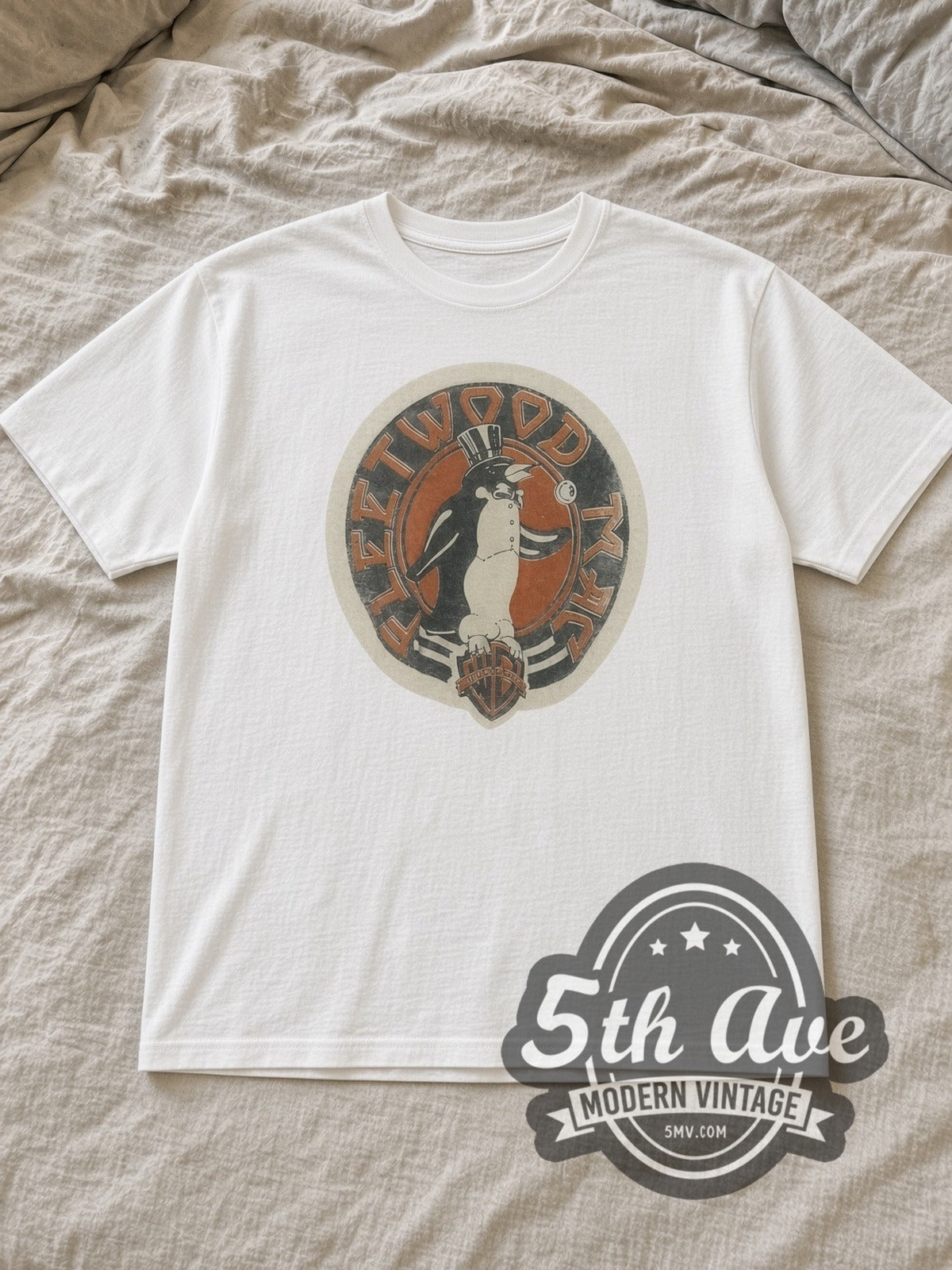 White Fleetwood Mac Penguin Logo Vintage Band T-Shirt laid flat on a linen bed