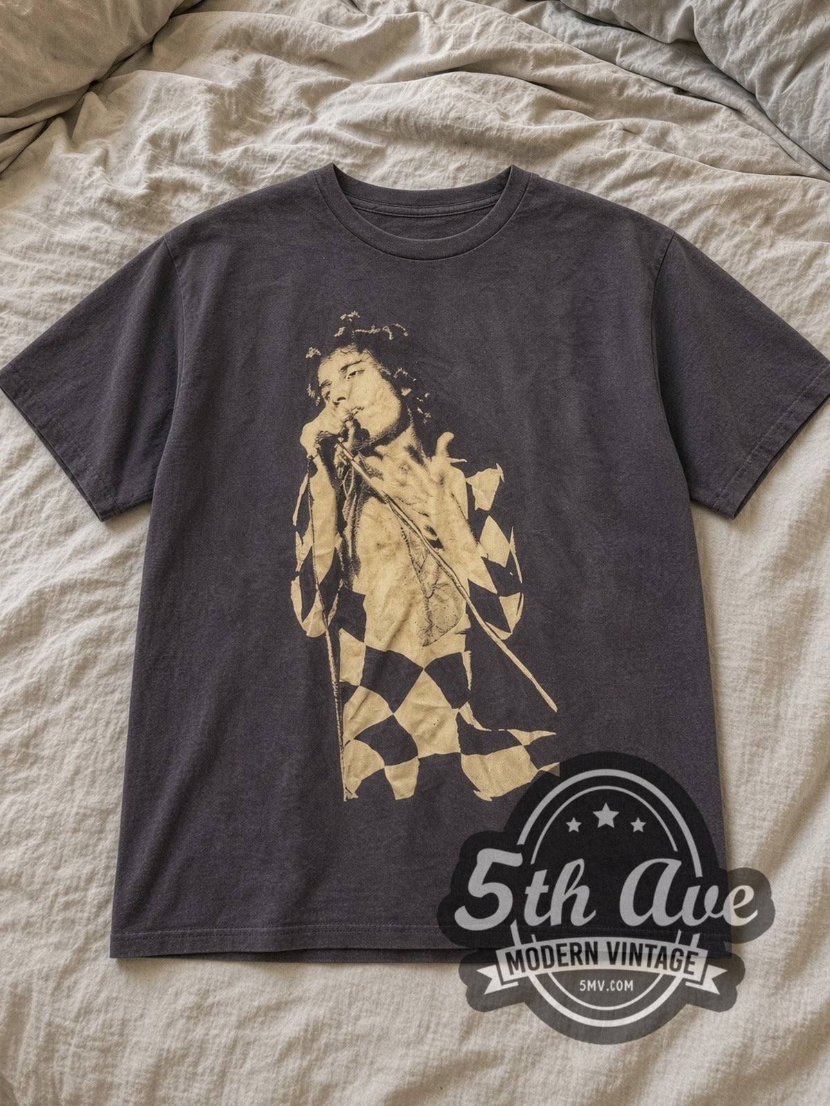 Charcoal Freddie Mercury Harlequin Stage Portrait Vintage Band T-Shirt laid flat on a linen bed
