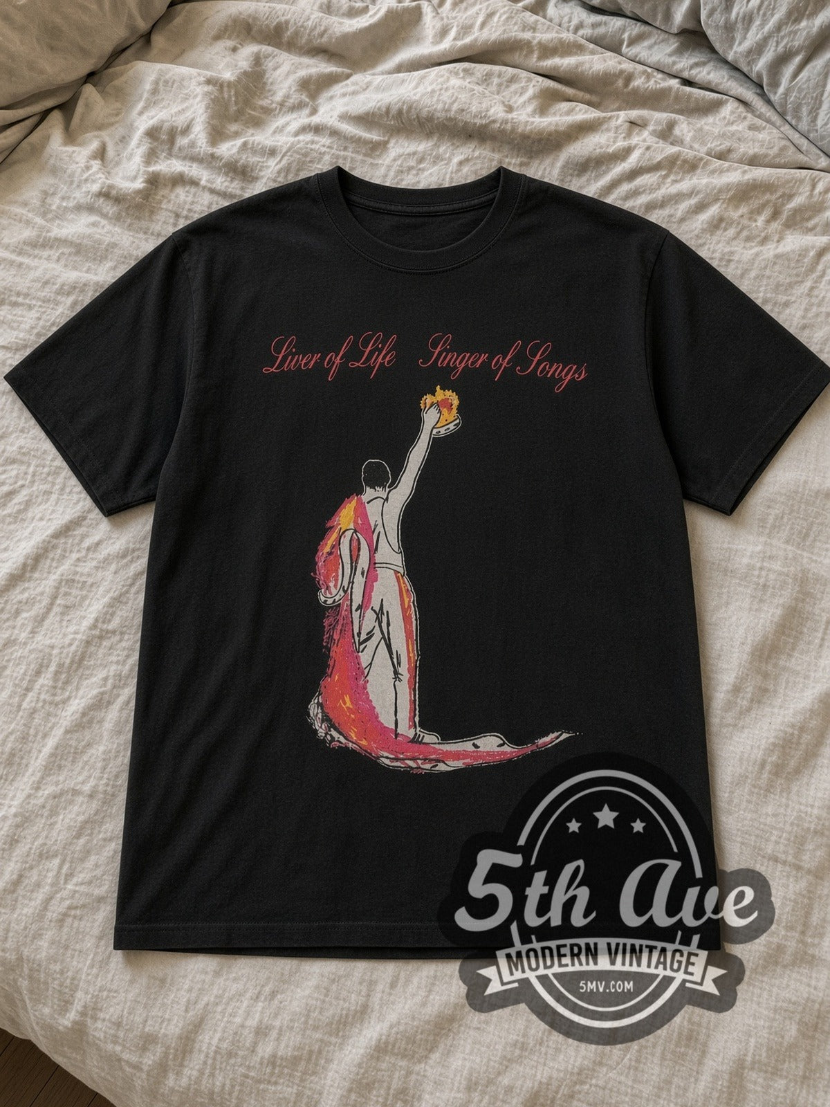 Black Freddie Mercury Lover of Life, Singer of Songs Vintage Band T-Shirt laid flat on a linen bed