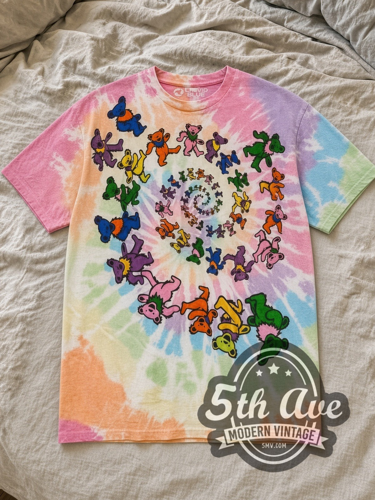 Tie-Dye Grateful Dead Spiral Bear Tie Dye All-Over Print Vintage Band T-Shirt laid flat on a linen bed