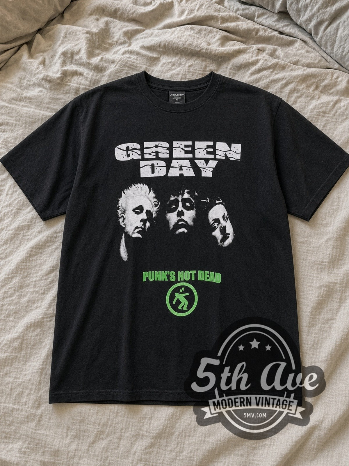 Black Green Day Punk Not Dead Vintage Band T-Shirt laid flat on a linen bed