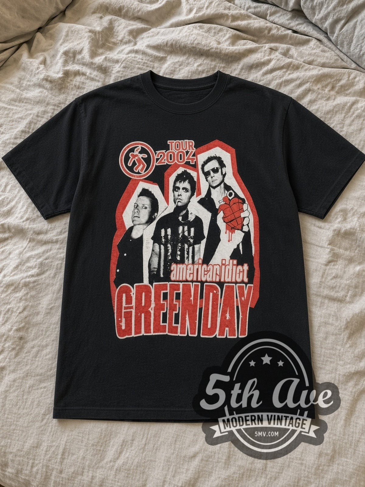 Black Green Day American Idiot Tour 2004 Vintage Band T-Shirt laid flat on a linen bed