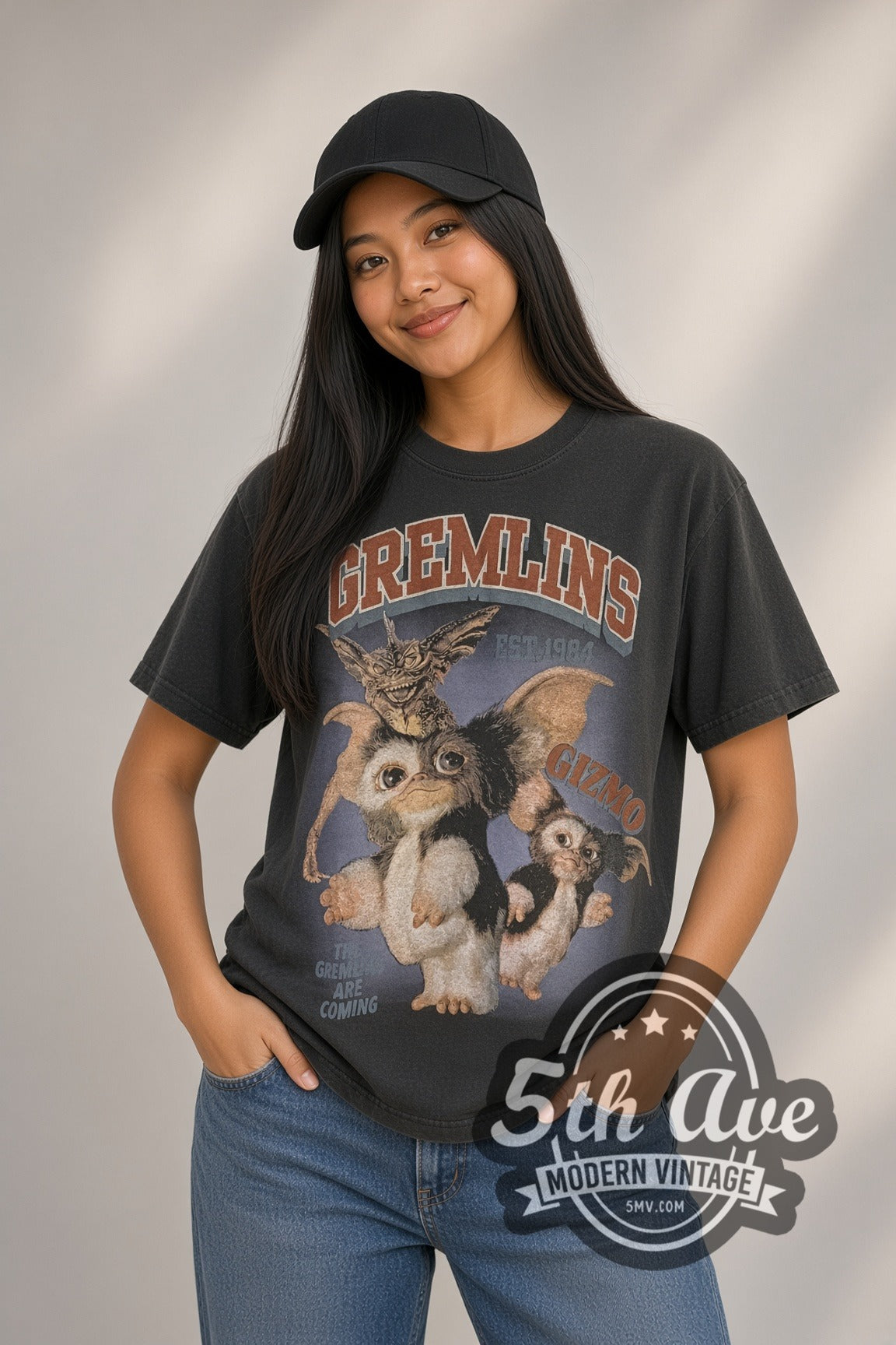 Woman wearing faded black Gremlins Est. 1984 Gizmo & Stripe / Gizmo in a Box vintage movie tee
