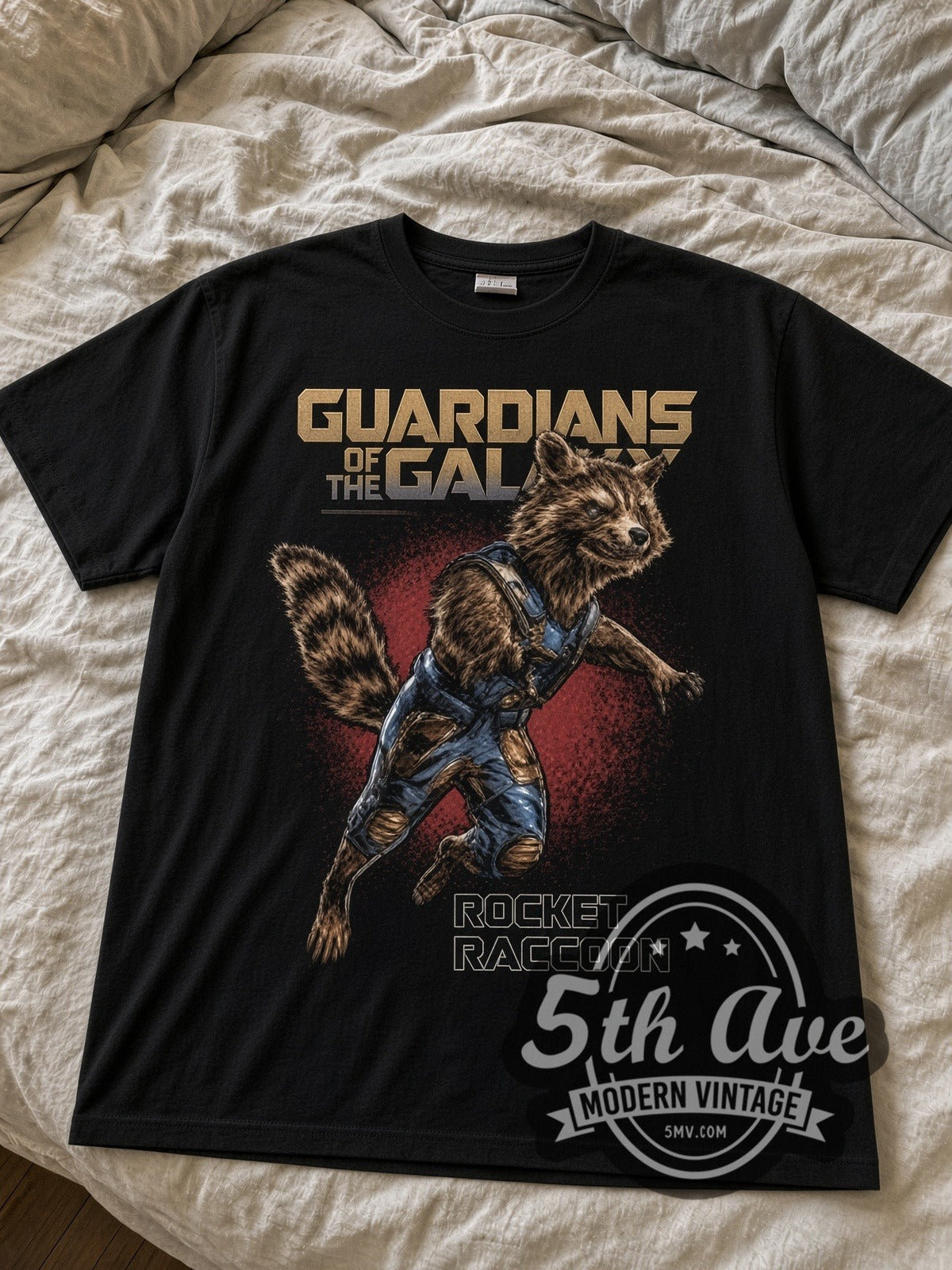 Rocket Raccoon black graphic tee laid flat on linen bed