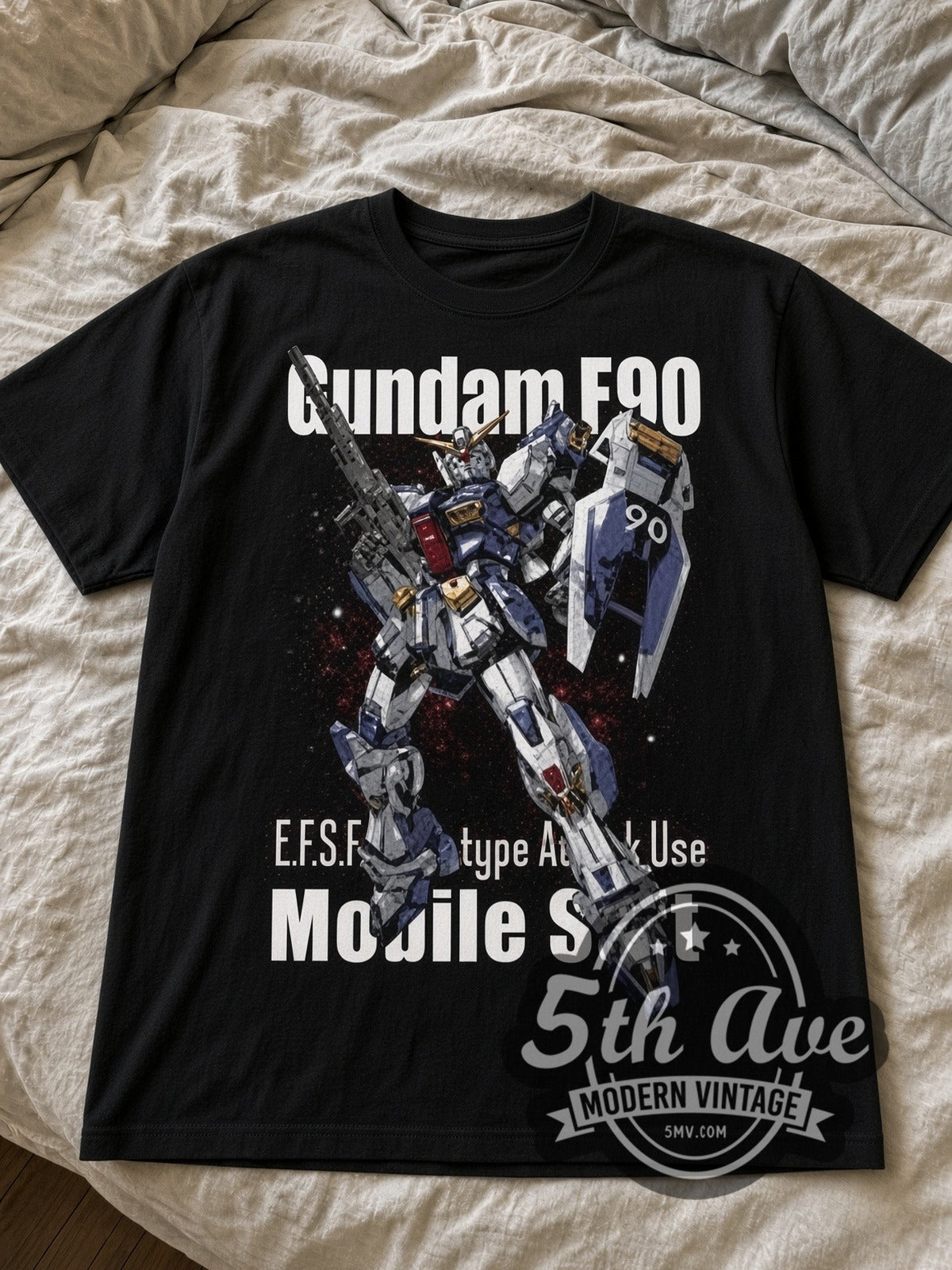 Gundam F90 black graphic tee laid flat on linen bed