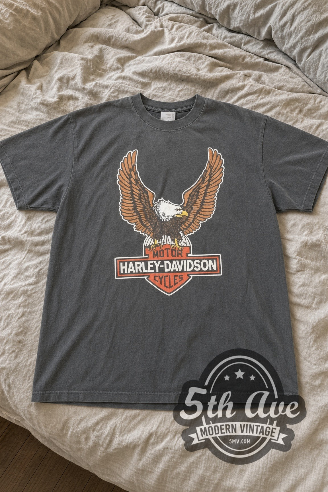 Harley-Davidson Classic Eagle Bar and Shield Dealer Back vintage graphic tee laid flat on bed