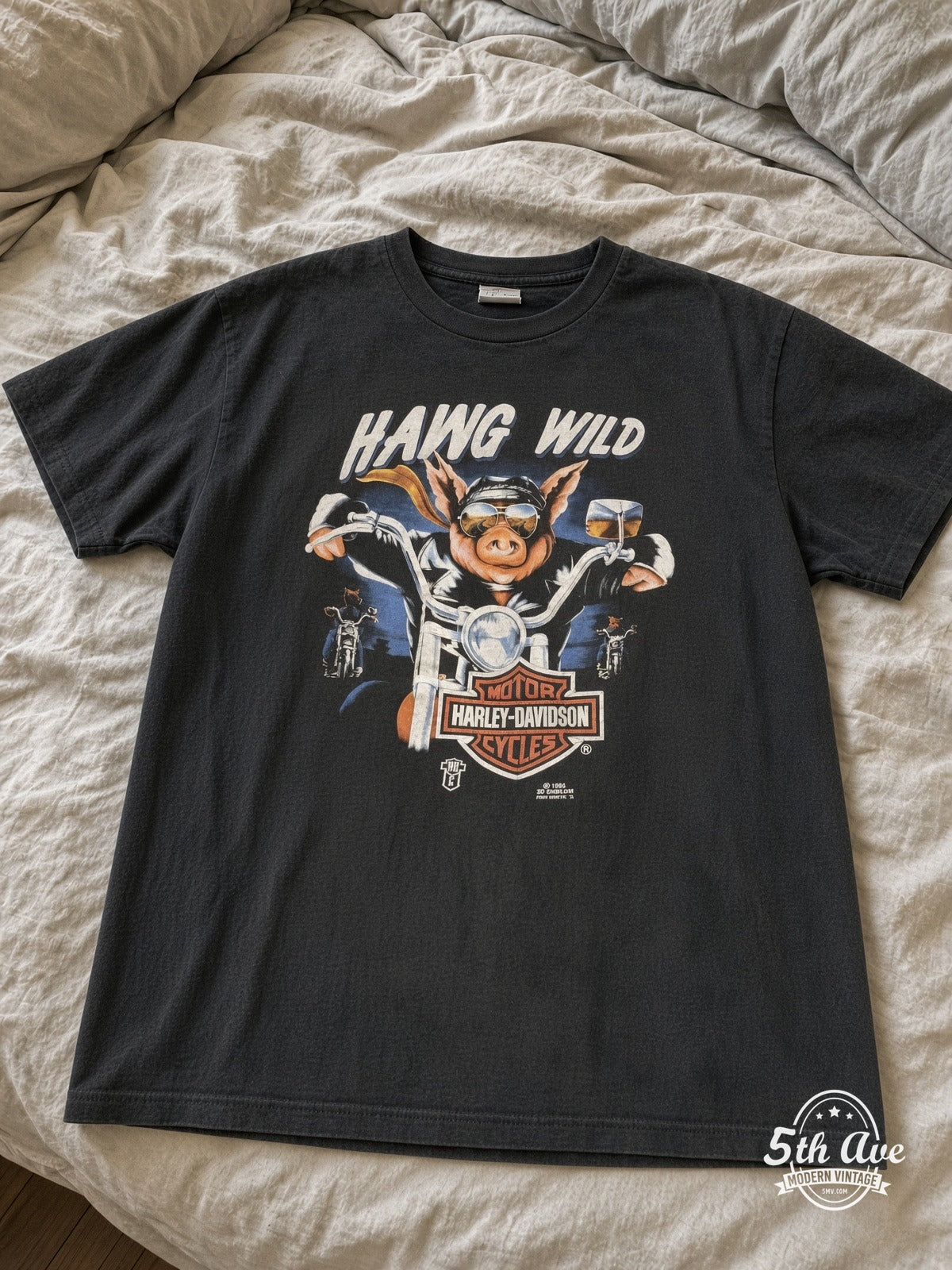 Harley-Davidson Hawg Wild Andy's Grand Forks ND vintage tee laid on bed