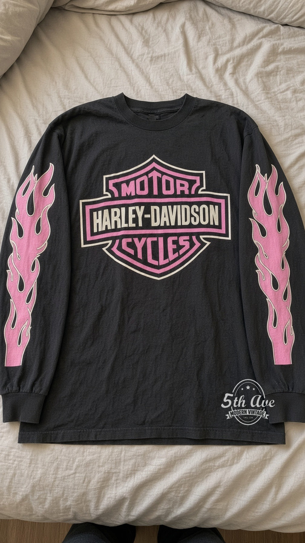 Harley-Davidson Wisconsin Oconomowoc Pink Shield long sleeve vintage t-shirt laid on bed