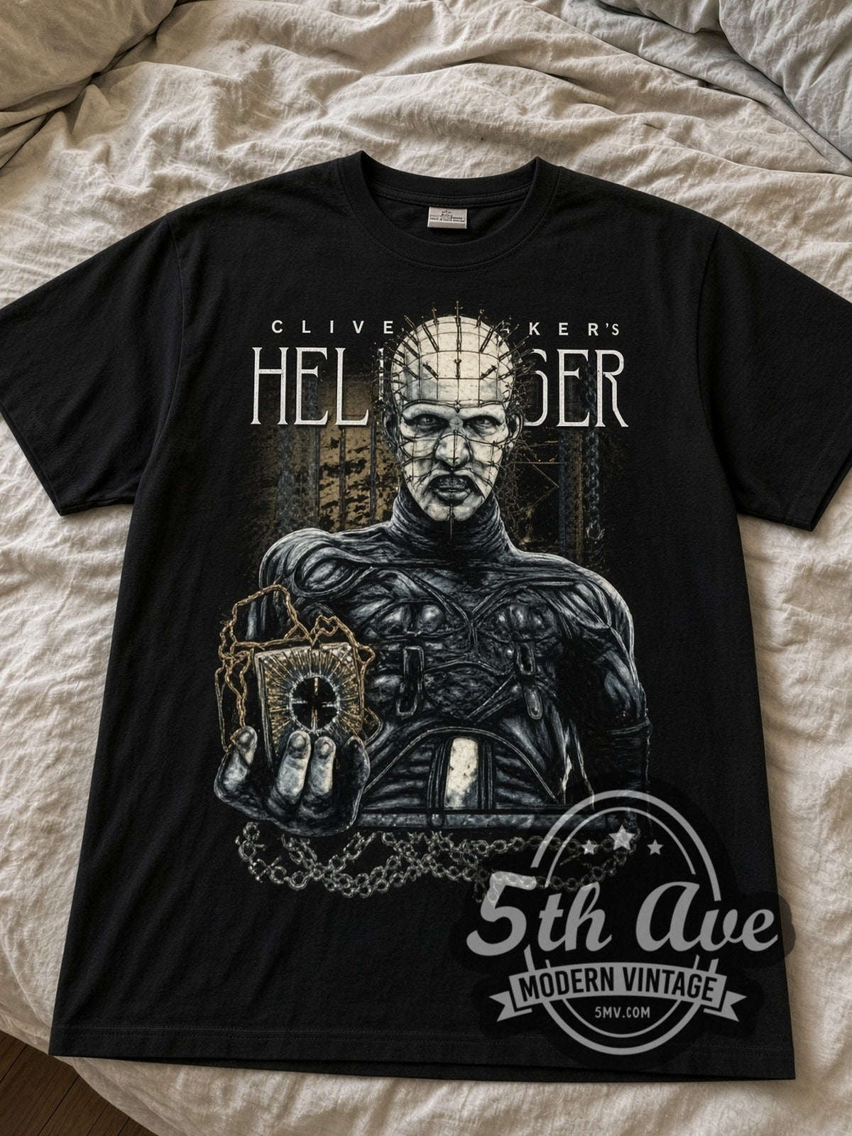 Hellraiser Pinhead puzzle box black graphic tee laid flat on linen bed