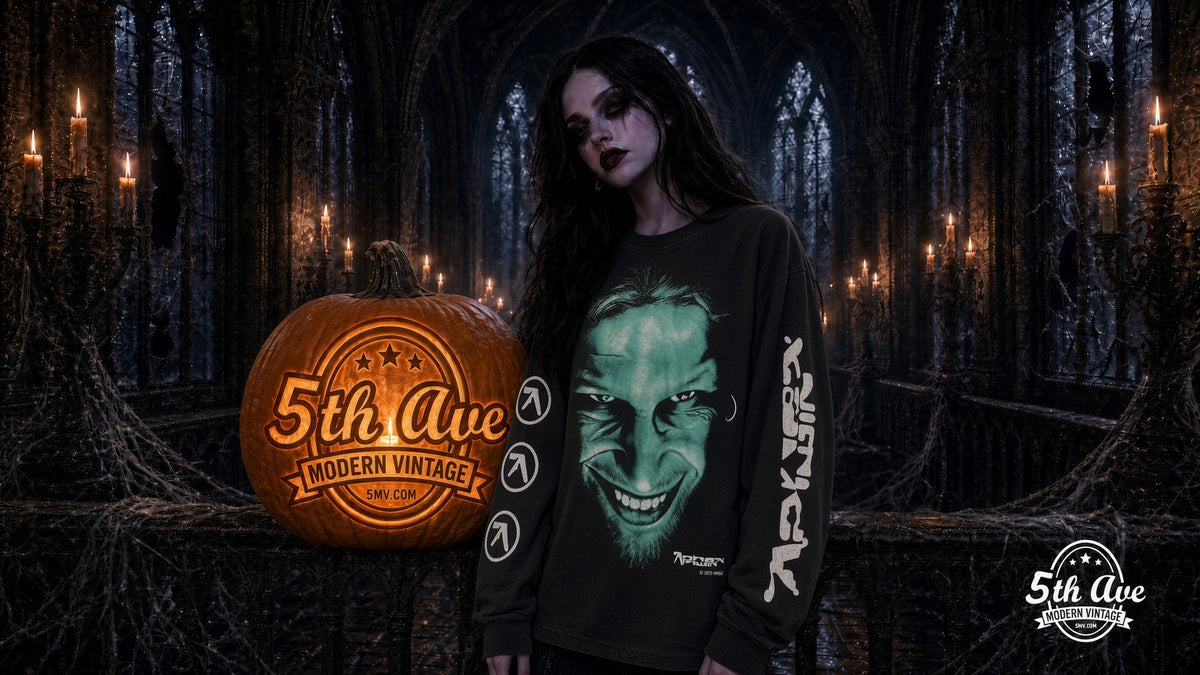 Model in faded black Aphex Twin Richard D. James Grin long sleeve tee beside a carved 5th Ave pumpkin