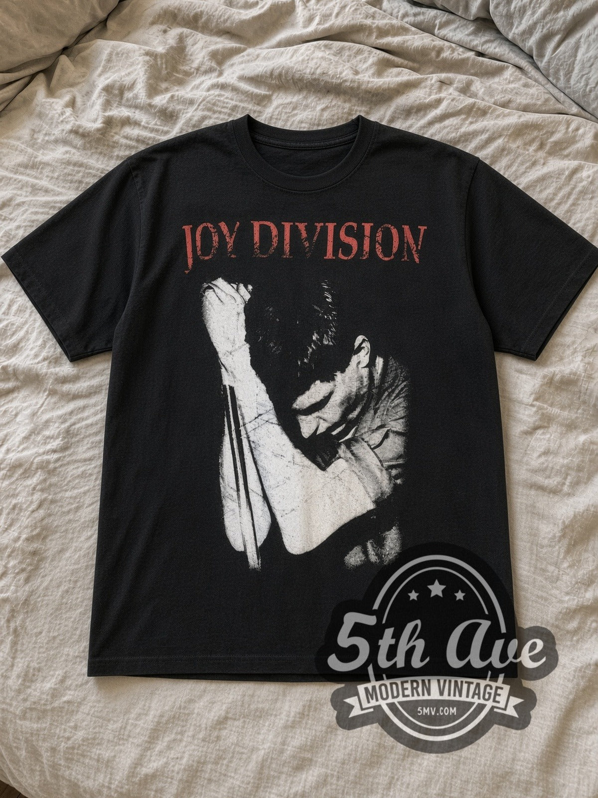 Black Ian Curtis Joy Division Vintage Band T-Shirt laid flat on a linen bed